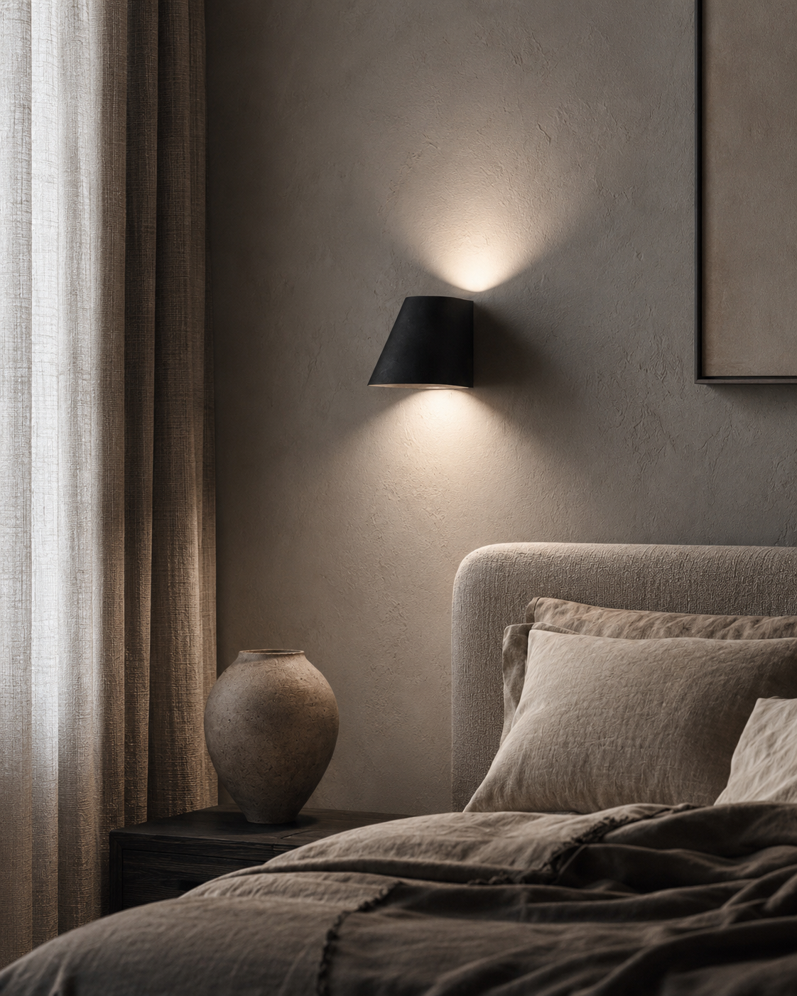 Bedroom decor ideas with soft bedside lamp, wall sconce, upholstered bed, linen curtains, wall art, ceramic vase, and evening shadows