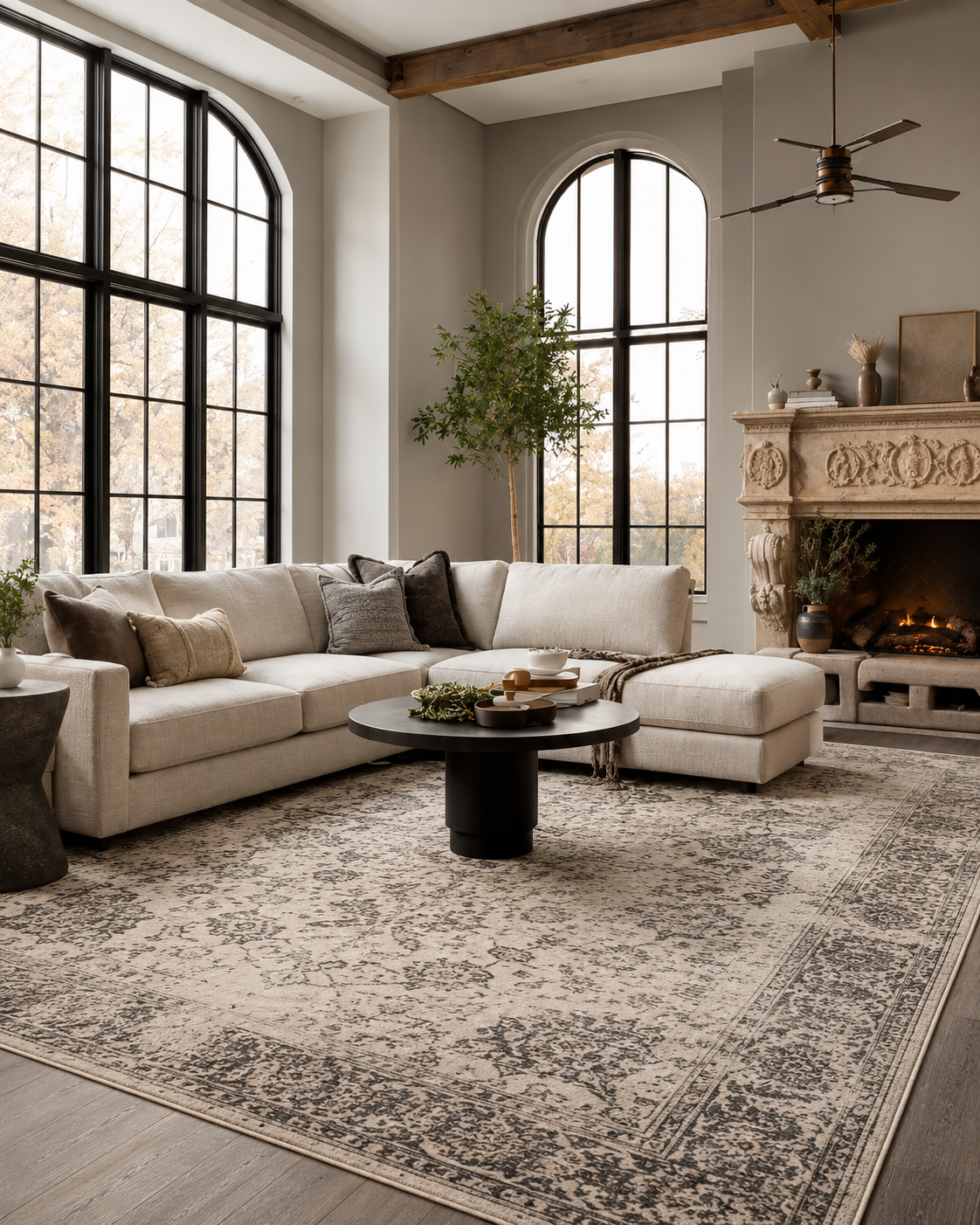 Living room rugs lookbook with easy-clean patterned area rug, neutral sectional sofa, and warm wood coffee table