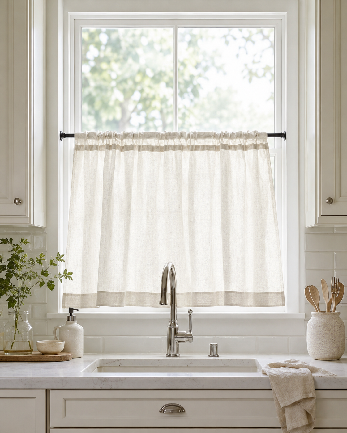 Neutral cafe curtain kitchen window with soft linen half curtains, slim curtain rod, and bright natural daylight over a kitchen sink