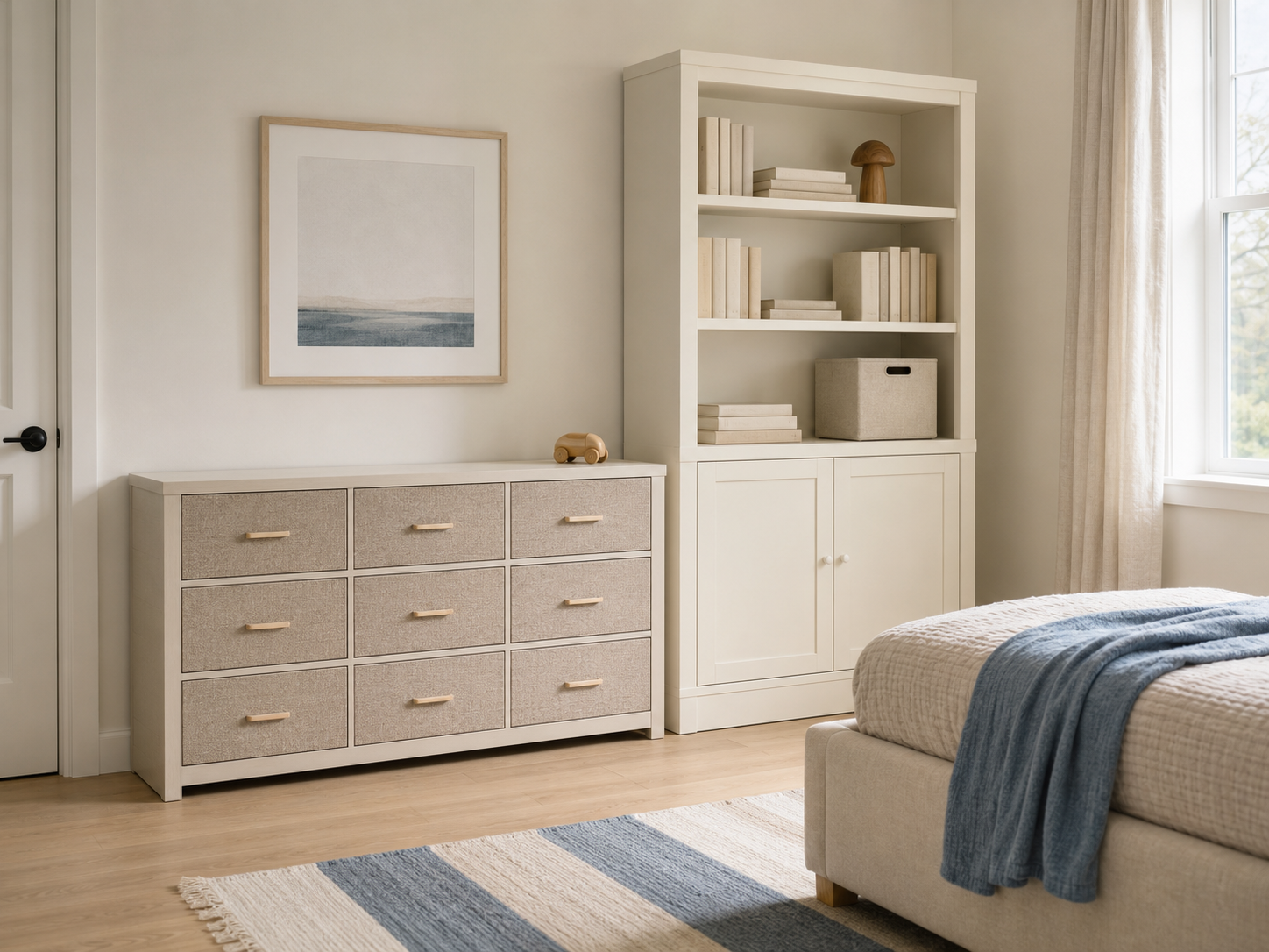 Calm kids bedroom with a wide fabric-drawer dresser, tall bookcase, closed lower cabinet and neutral cube storage bin.