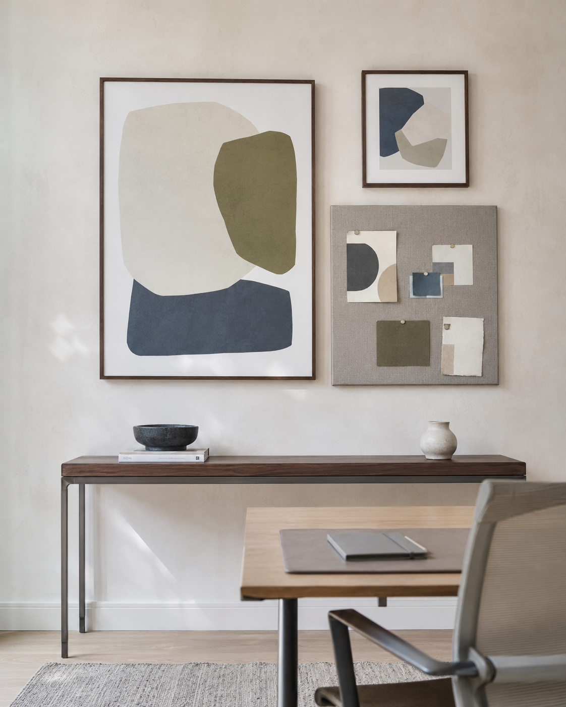 Abstract wall art and an organized inspiration board above a home office desk
