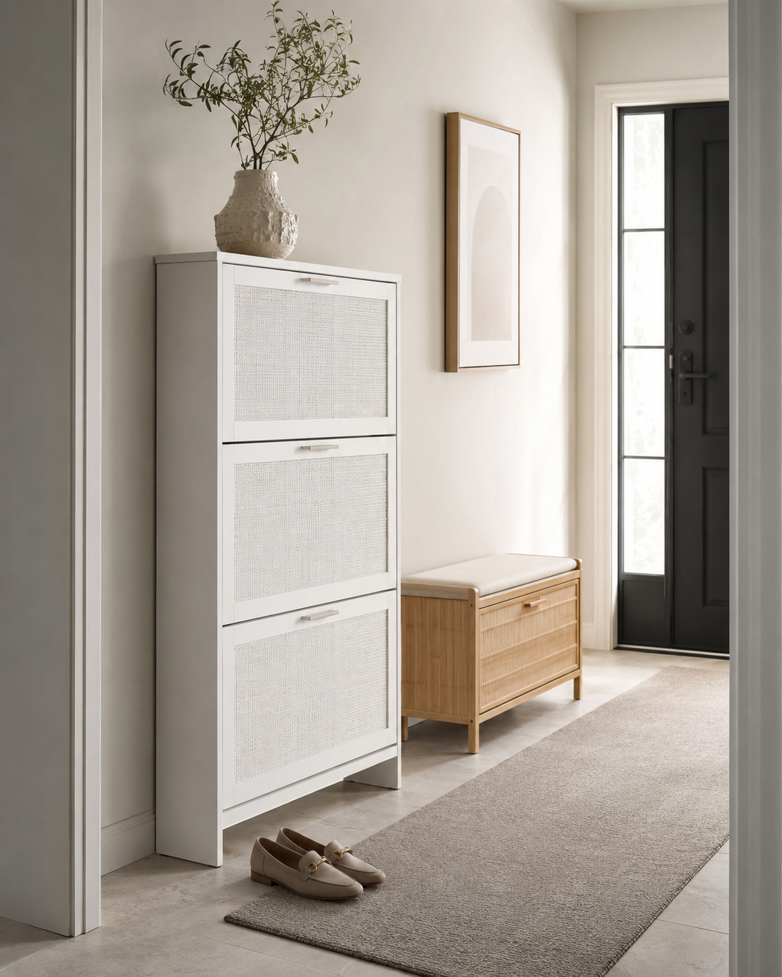 White rattan shoe cabinet and bamboo shoe bench in a neutral entryway