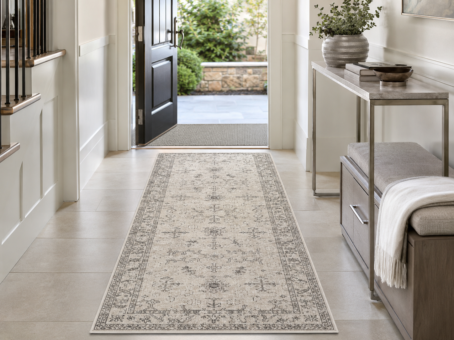 Neutral patterned entryway runner with an indoor doormat, slim console and upholstered storage bench