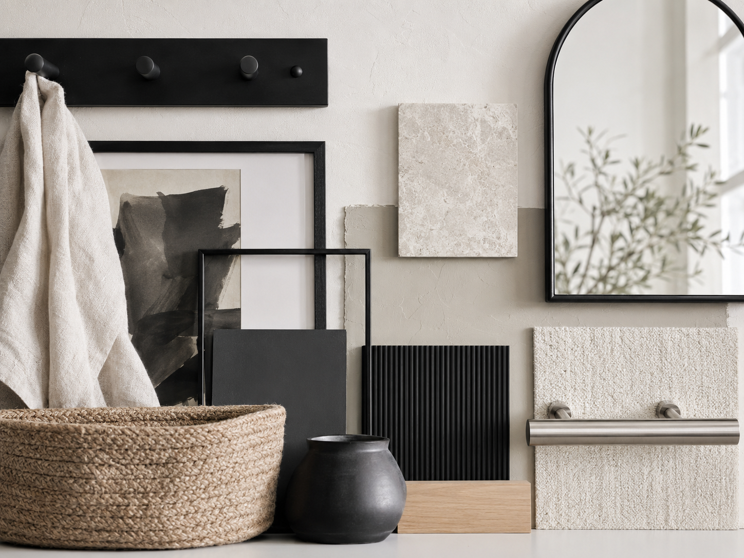 Modern entryway wall decor moodboard with black hooks, frames, stone texture, woven basket and fluted wall panel details.