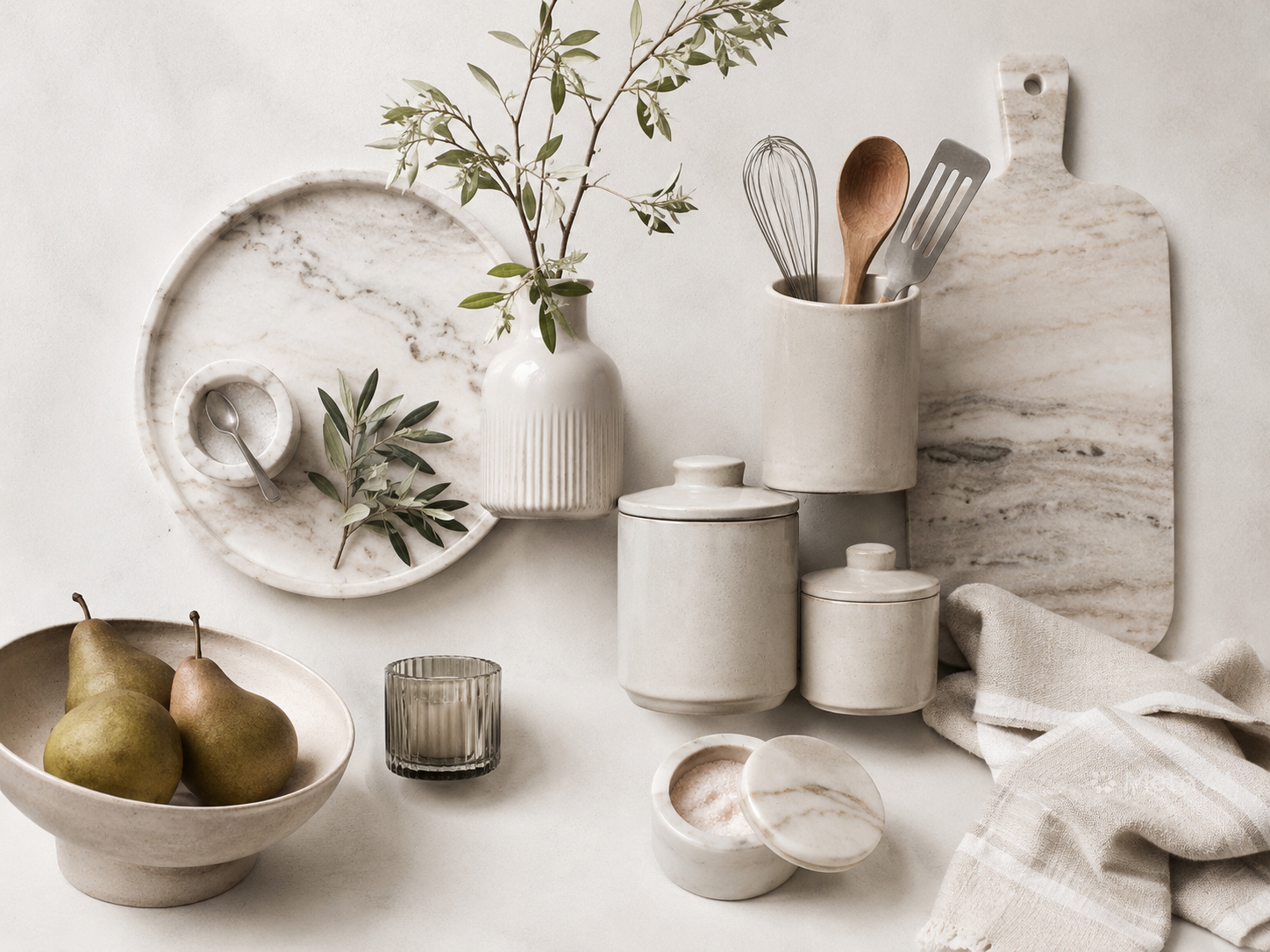 Kitchen counter decor moodboard with ceramic canisters, tray, vase, stone board, towels, and marble accents