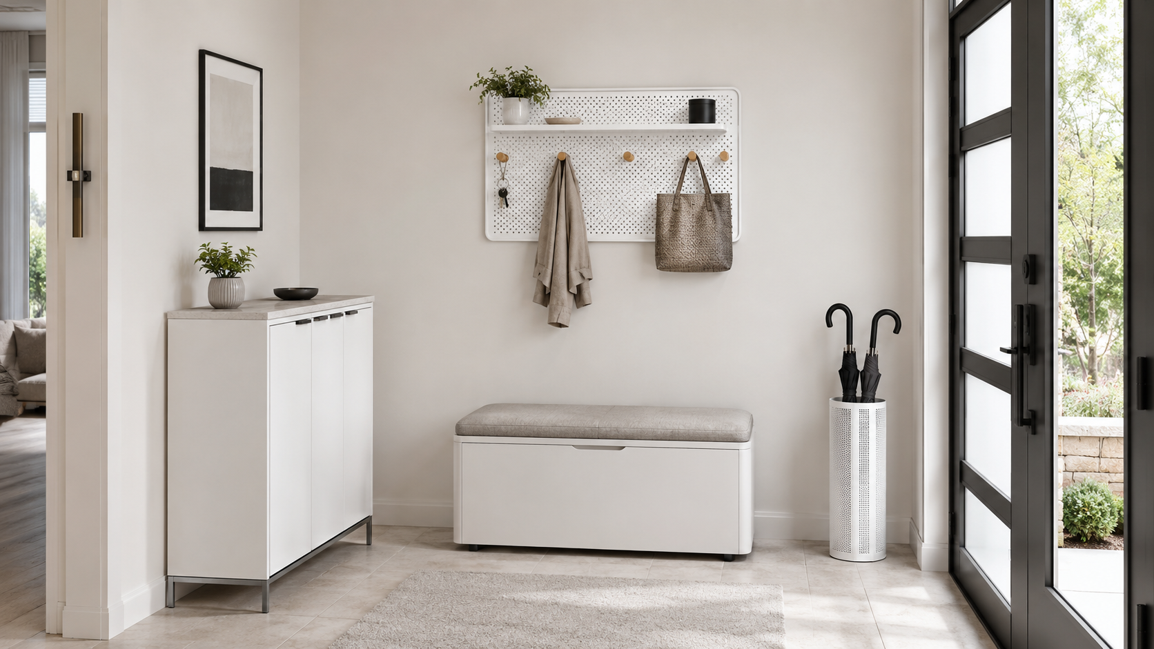 White entryway cabinet, storage bench, wall organizer and black umbrella stand arranged on a neutral background