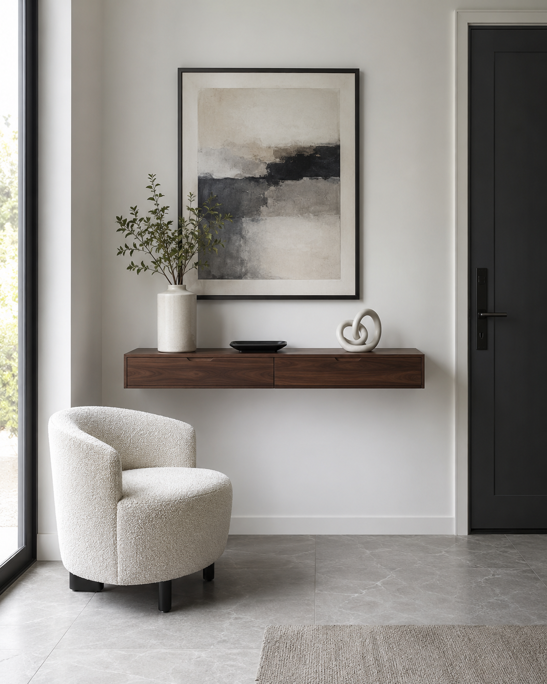 Apartment entryway with a walnut floating console and cream bouclé accent chair