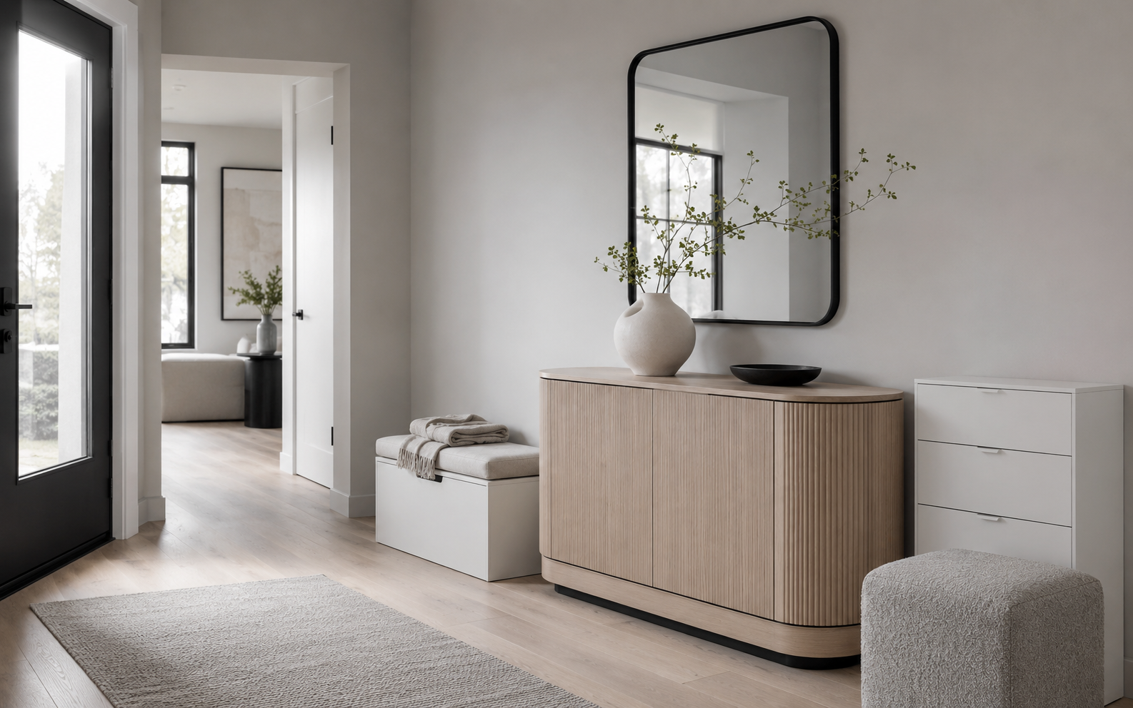 Finished entryway with a fluted console, storage bench, shallow cabinet and bouclé cube stool