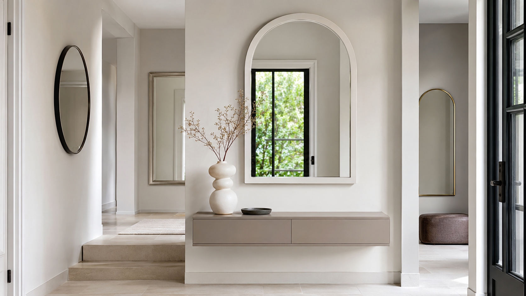 Finished entryway with arched mirrors above a floating console