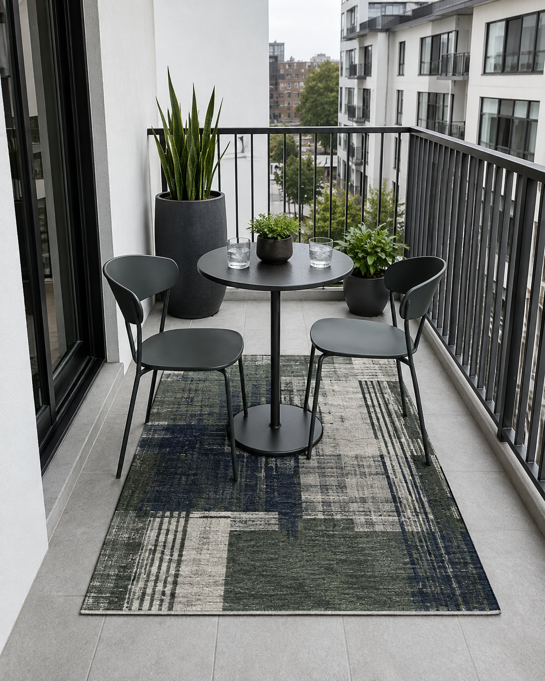 Compact modern balcony with a green and charcoal rug grounding a two-seat bistro arrangement