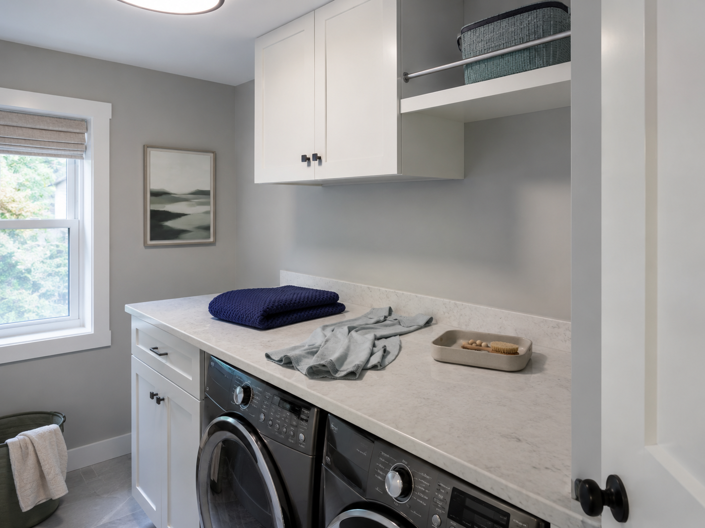 Laundry folding counter left in shadow because overhead cabinetry blocks the ceiling light.