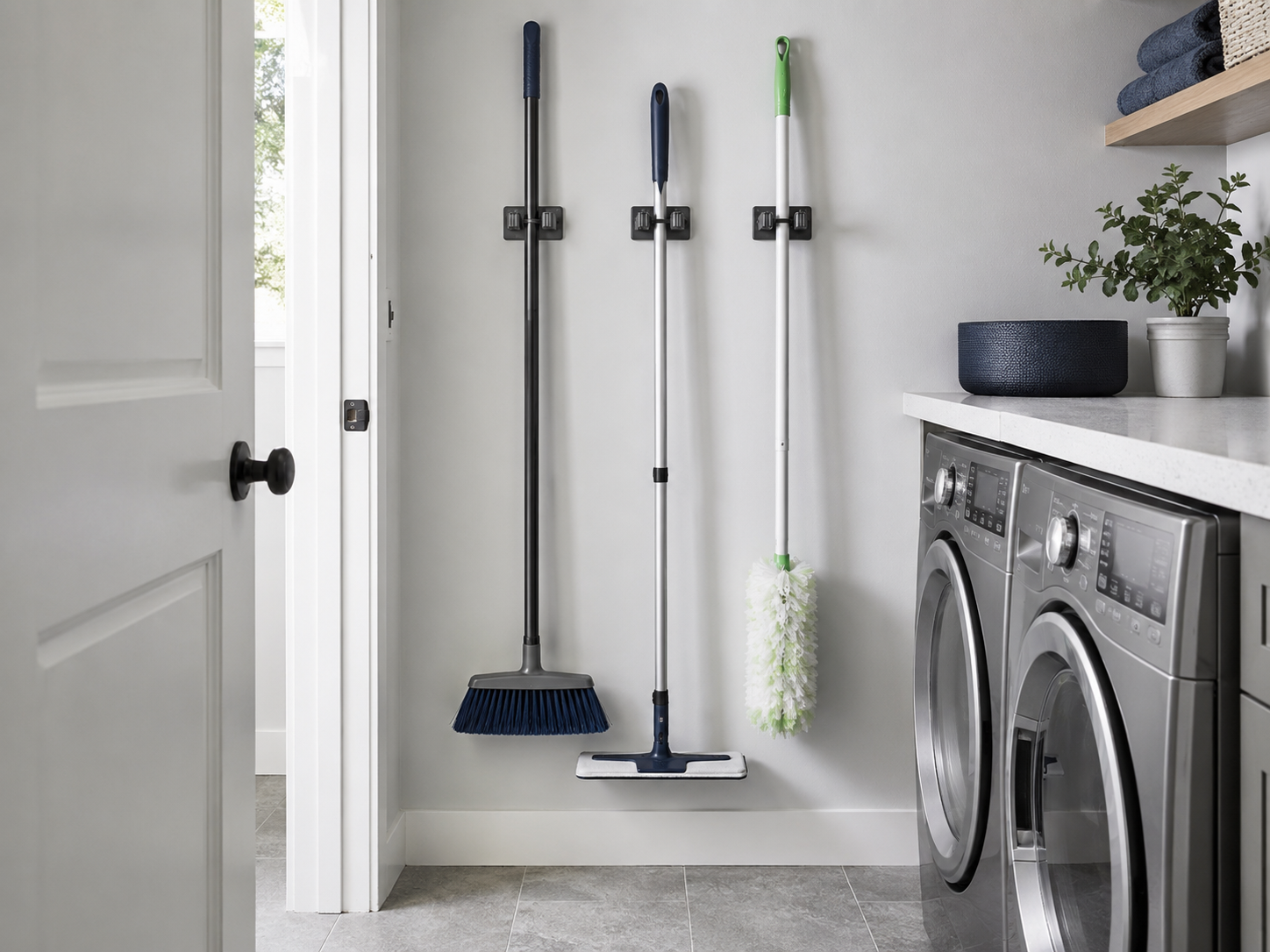 Laundry Wall Organization - Ravnora Decor Brooms and mops clipped vertically to a laundry-room wall while keeping the floor and doorway clear.