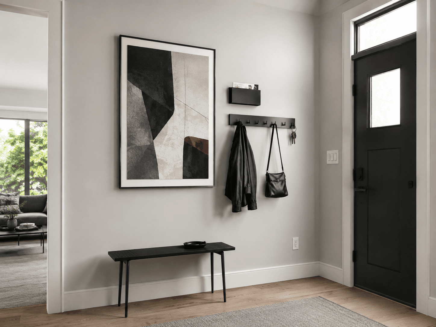 Function-first entryway wall with artwork, a compact organizer, hooks and contained everyday arrival storage