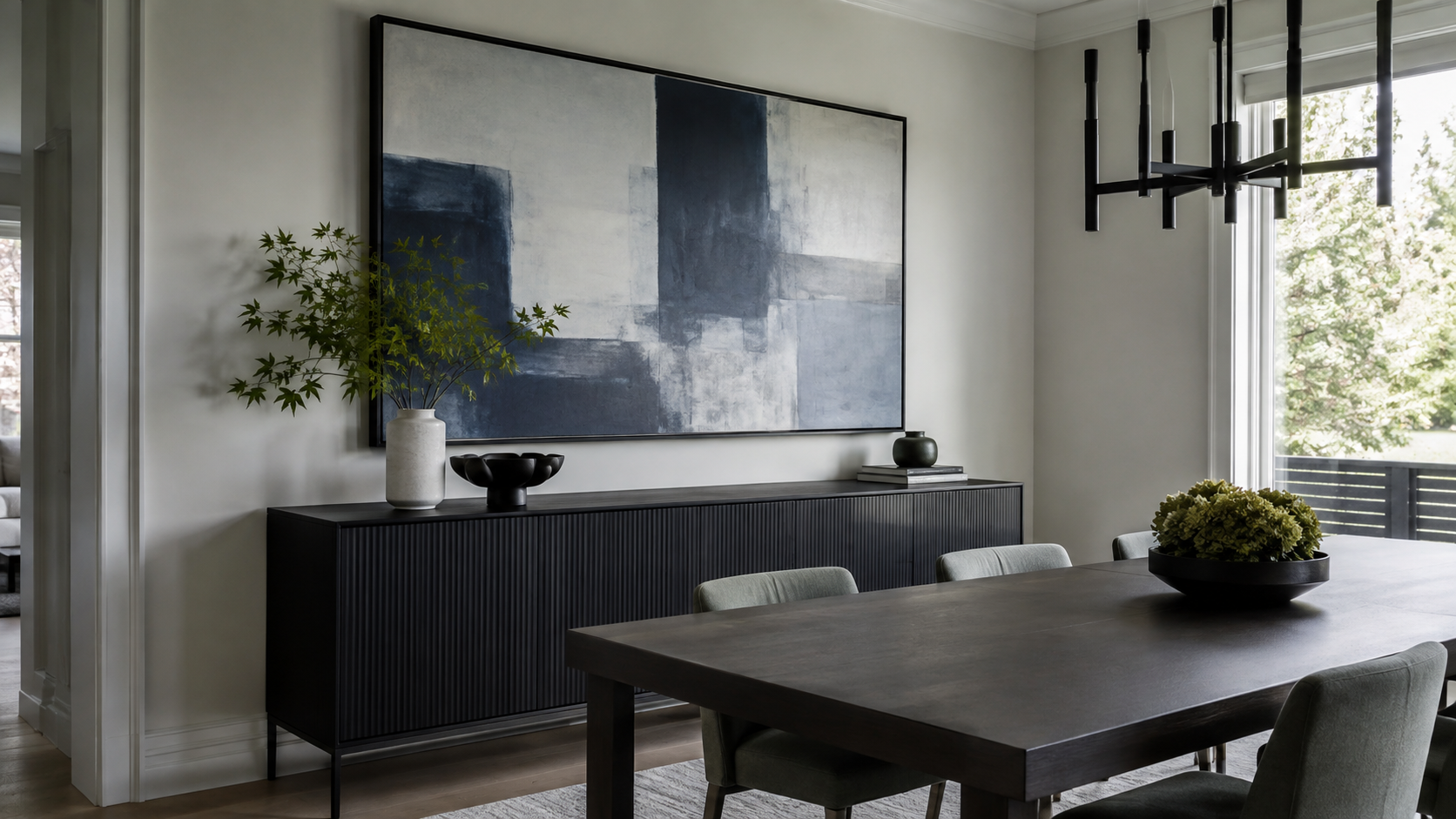 Contemporary dining room with oversized cool-toned abstract art above a dark sideboard