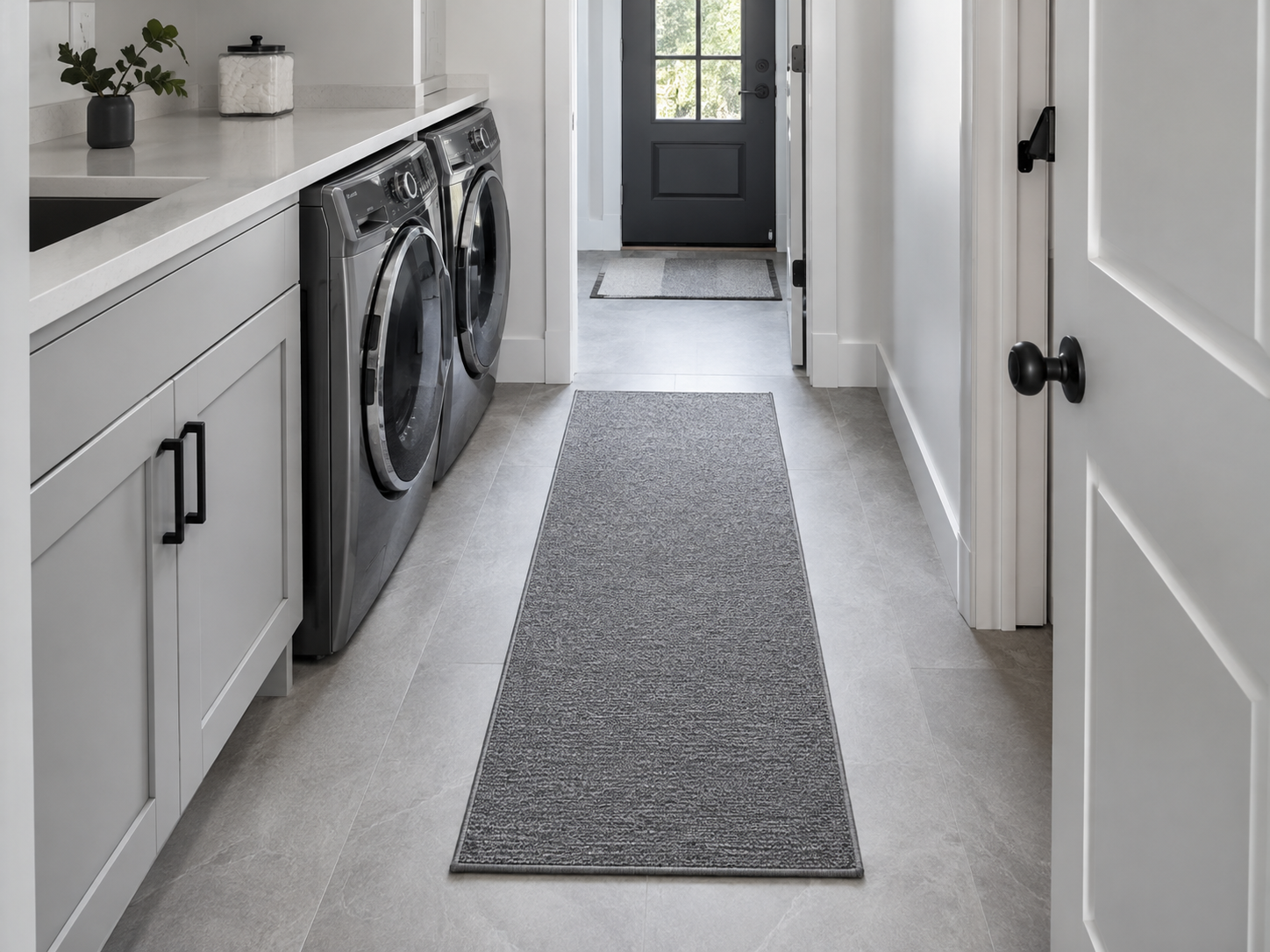 Low-profile gray laundry runner centered in a clear walking path without blocking appliance or doorway movement.