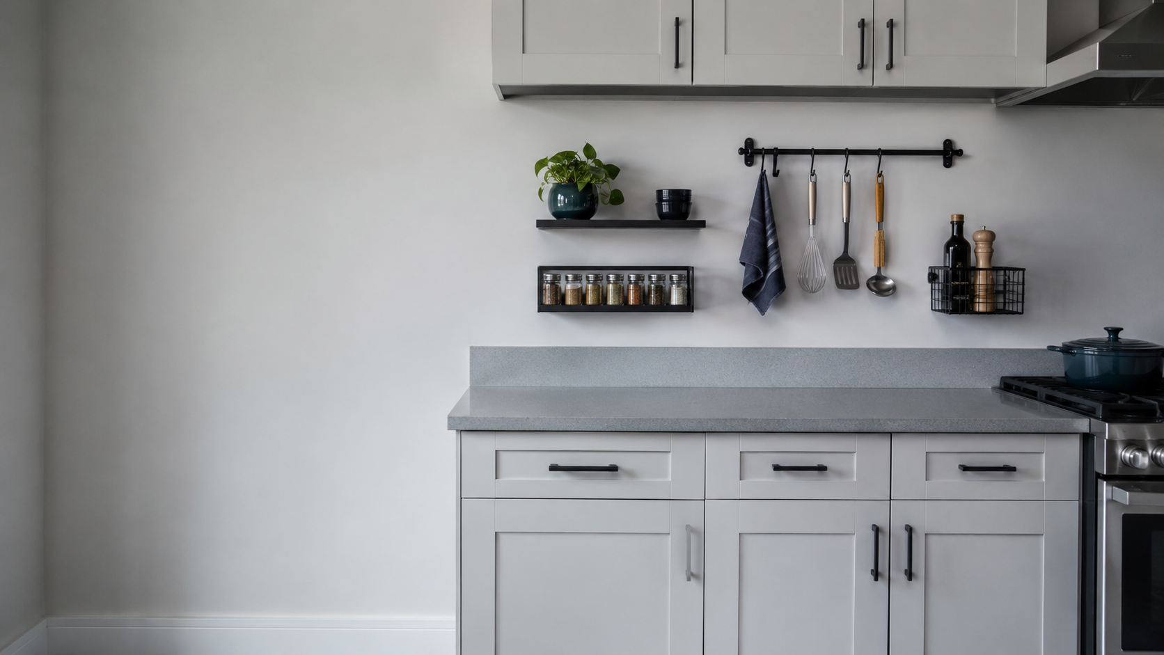 Contemporary kitchen with a clear worktop and coordinated wall shelves, rails and compact organizers