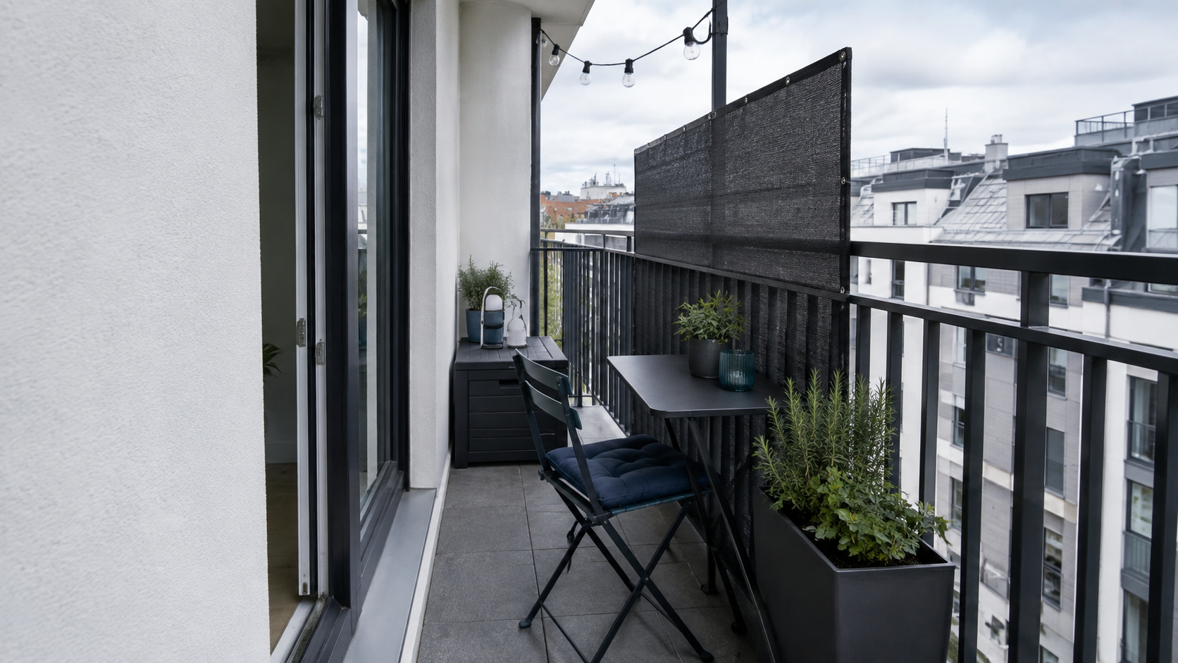 Small Balcony Solutions - Ravnora Decor Small apartment balcony where folding seating, table, planter and storage compete for one narrow walking route.