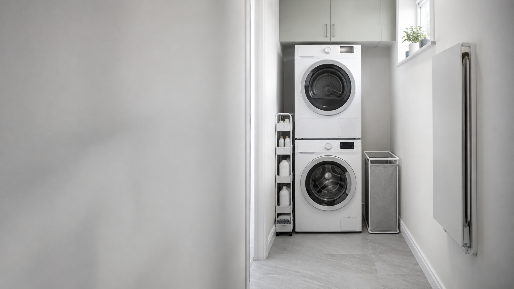 Small Laundry Room Solutions - Ravnora Decor Compact laundry room with stacked appliances, slim storage and a clear appliance and walking route.