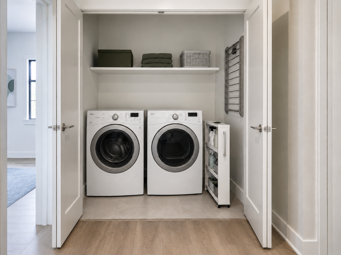 Small Laundry Room Solutions - Ravnora Decor Laundry closet with side-by-side appliances, slim rolling storage and clear access through the open closet doors.