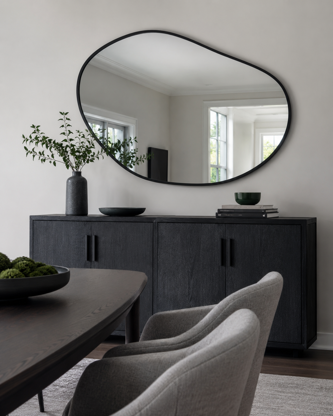 Contemporary dining-room sideboard wall with a large black organic mirror