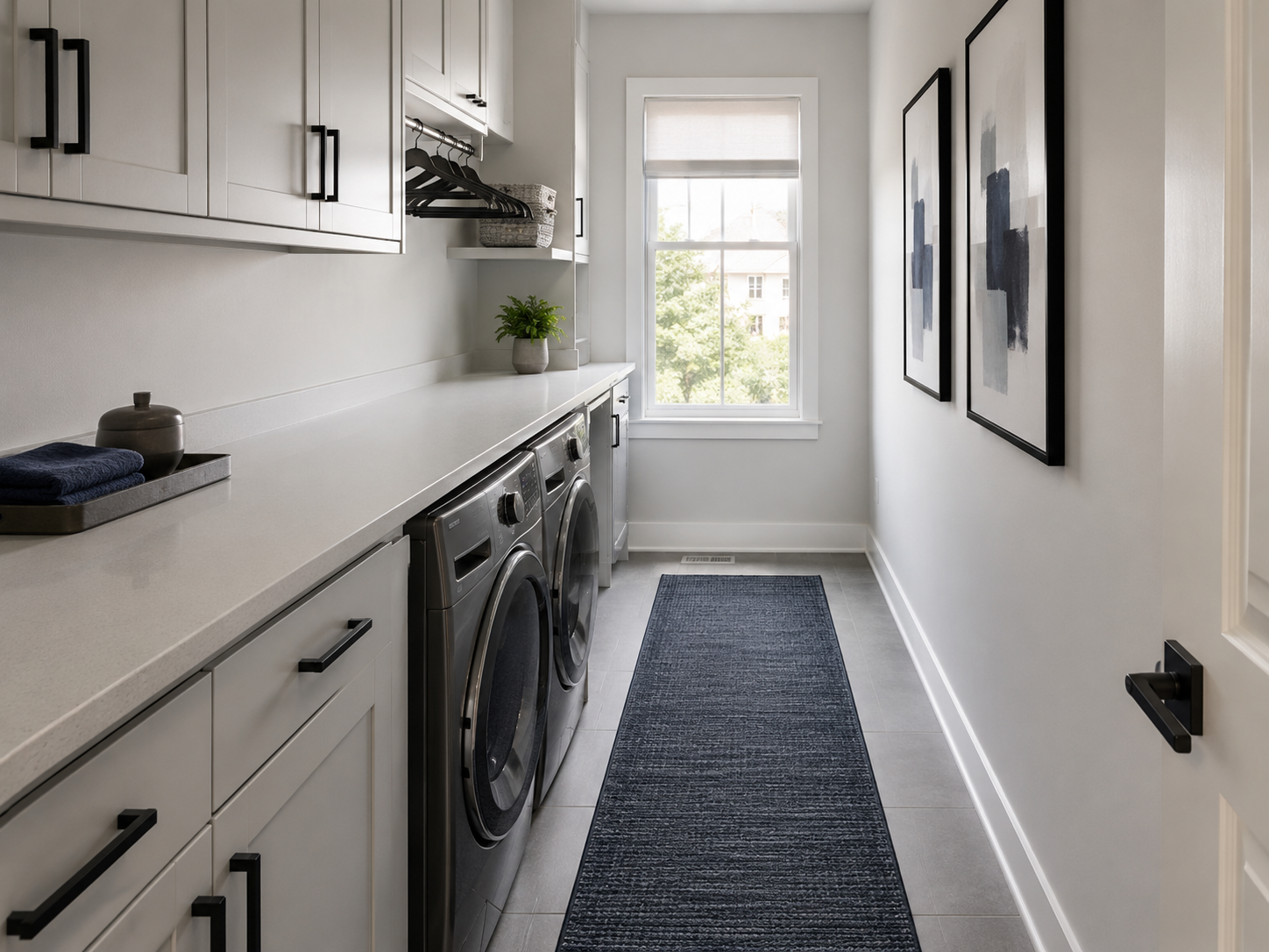 Narrow cool-gray laundry room where the runner and wall treatment lead while supporting details stay restrained.