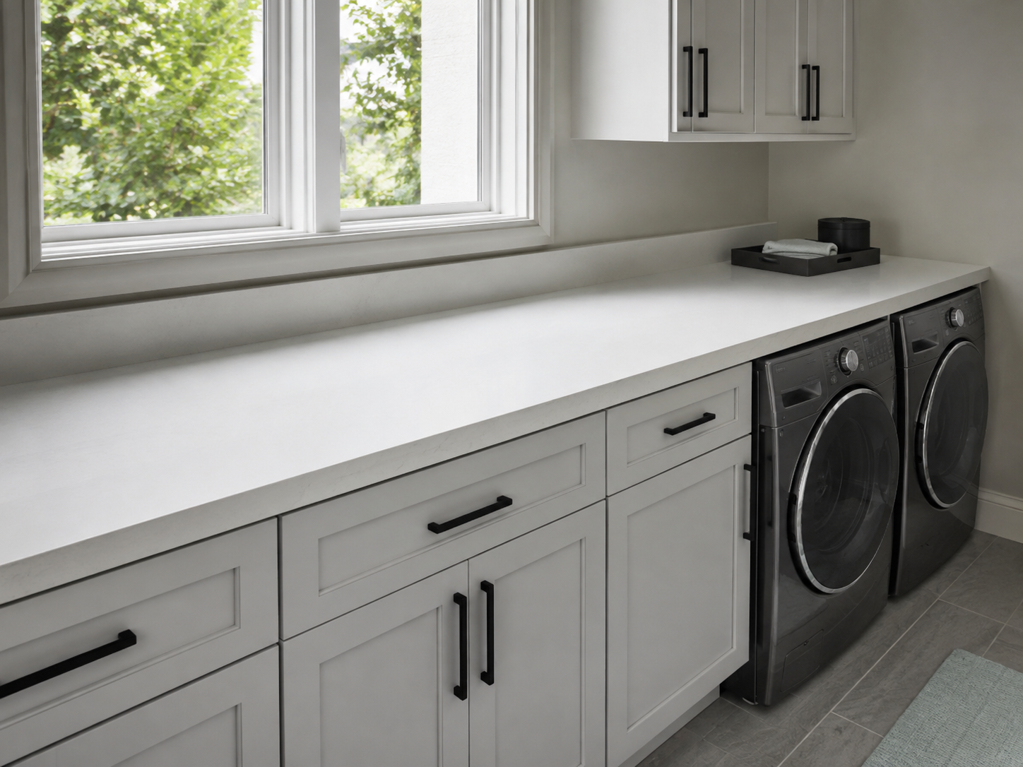 Long clear laundry folding counter with one small decorative tray confined to the far edge.