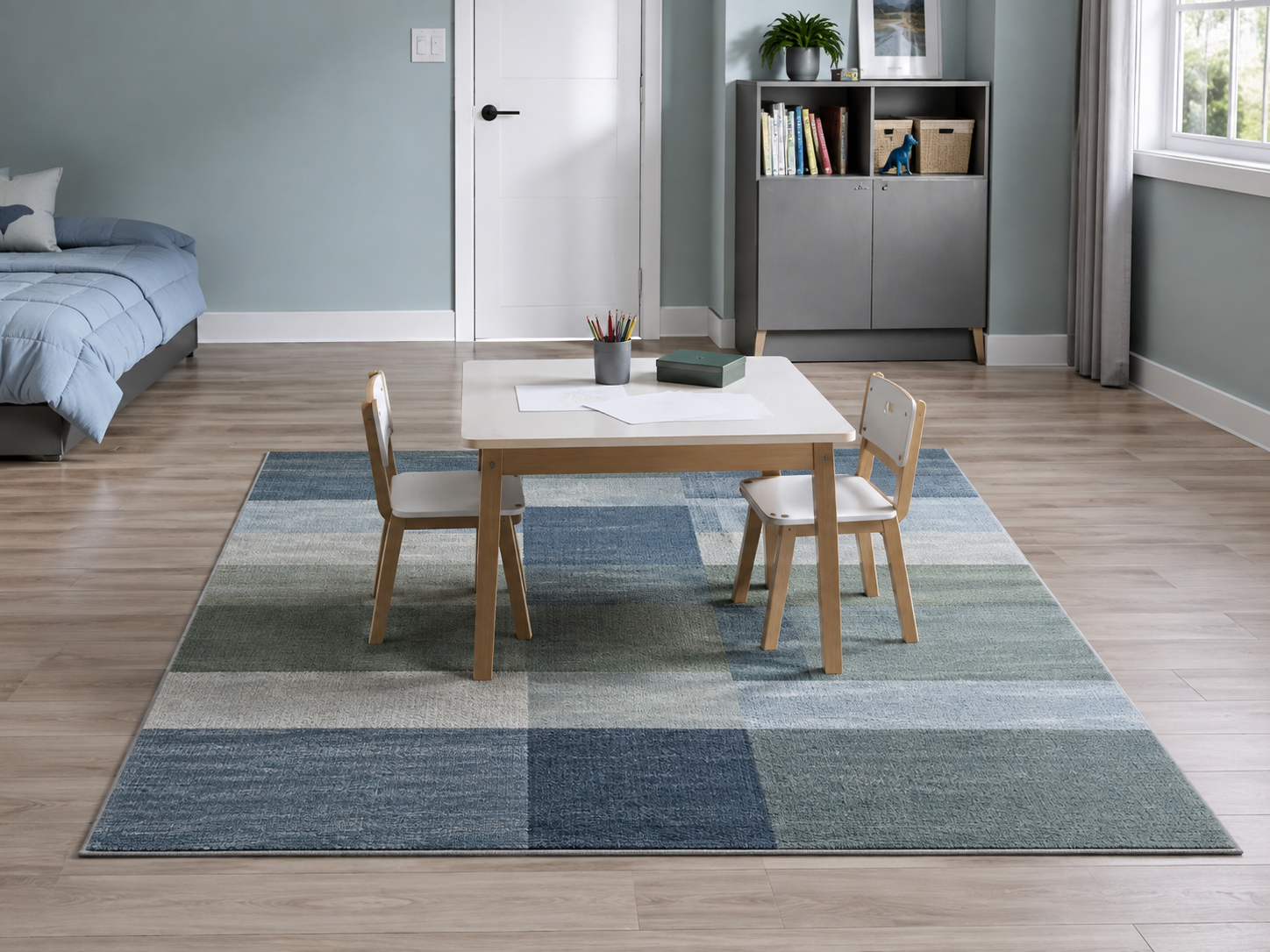 Kids creative table positioned on a clearly defined low-profile rug zone with open floor visible around it