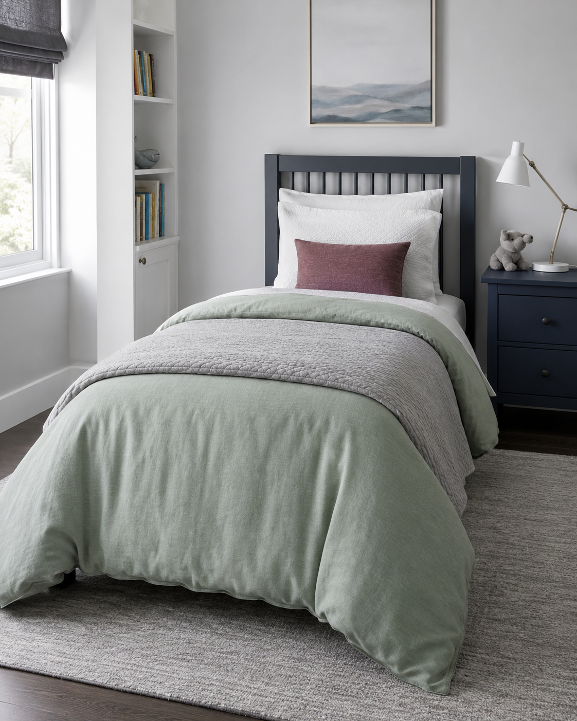 Soft-color kids bedding route in sage, cool gray and a small muted plum accent.