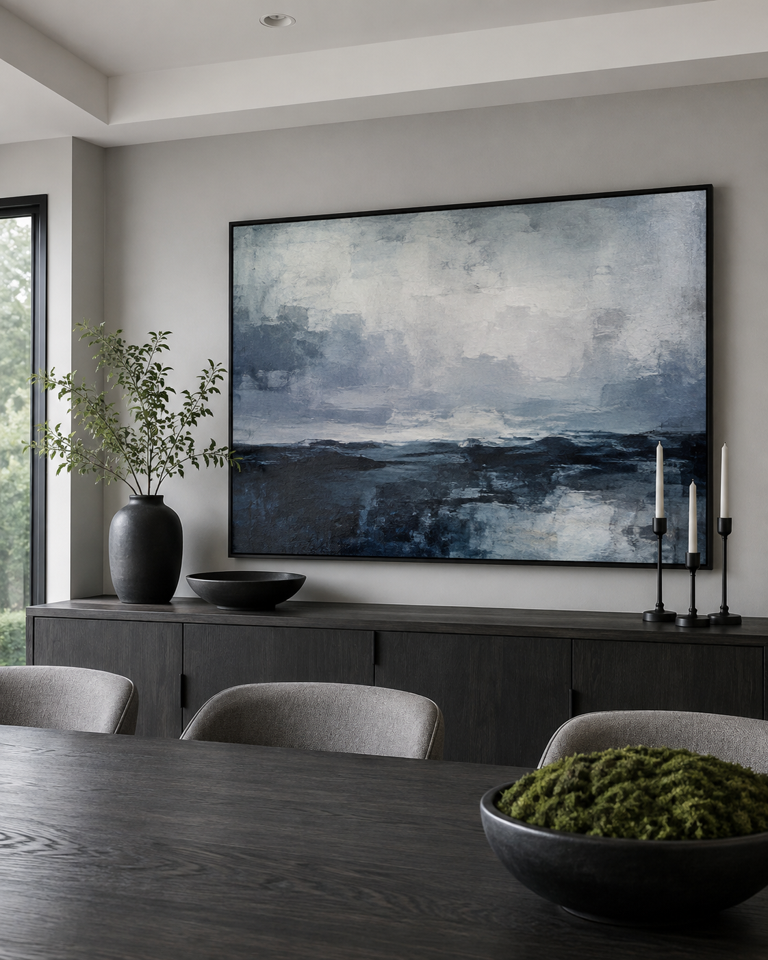 Dining room wall anchored by correctly scaled cool-toned statement art