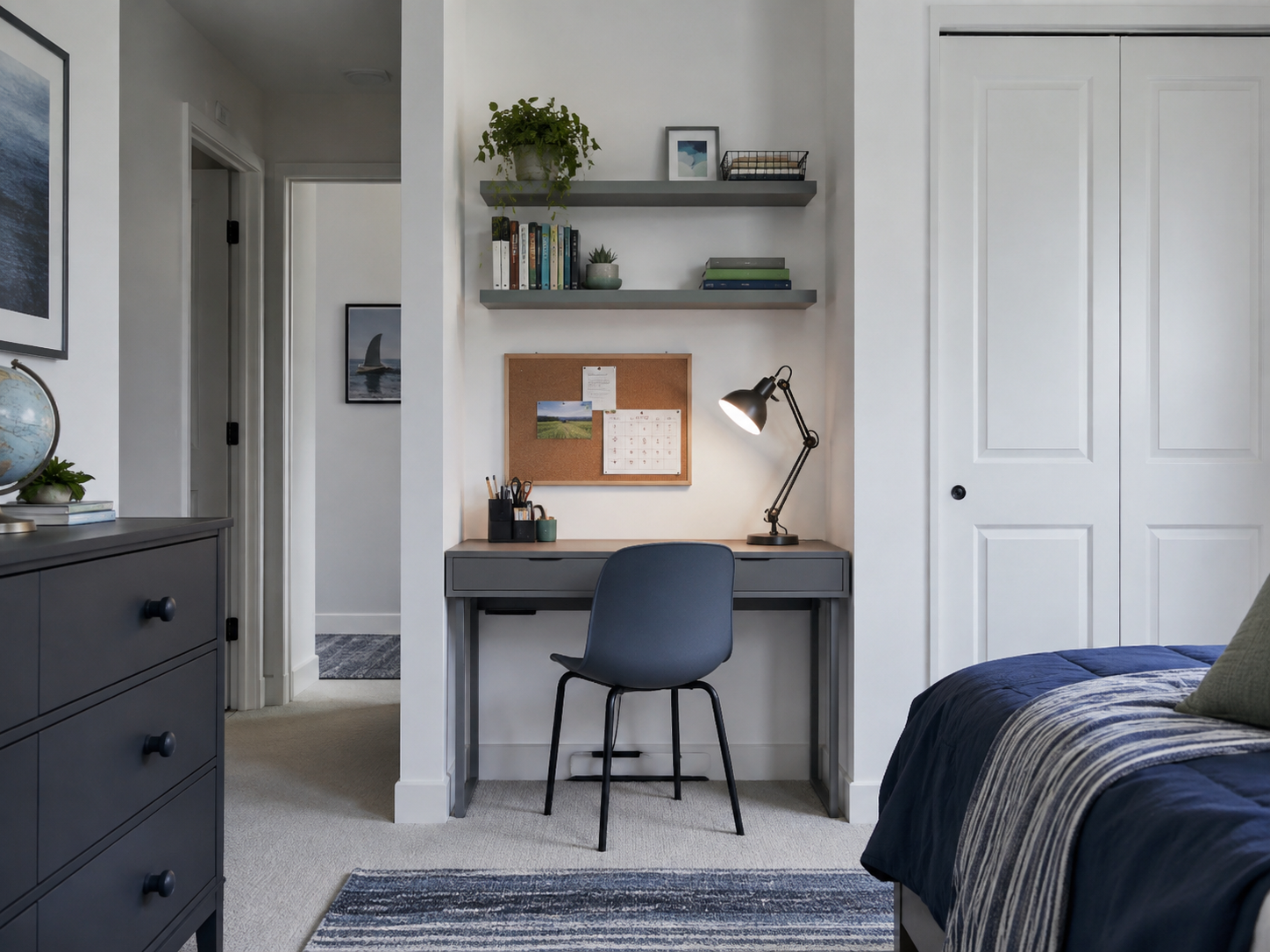 Compact wall study niche with a shallow desk, chair, task lamp and reachable book storage in a kids bedroom.