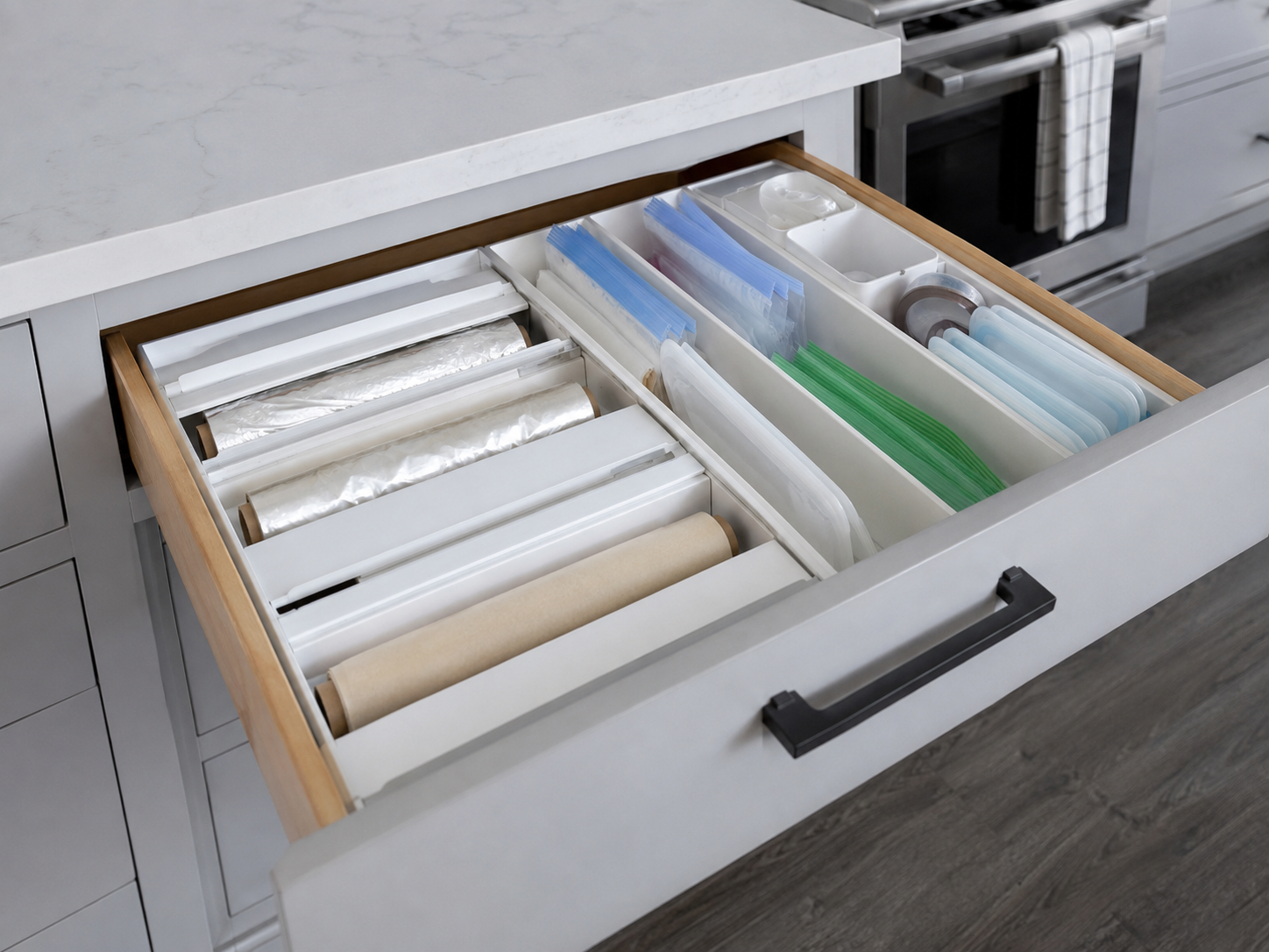Kitchen drawer separating food wrap rolls from upright food-storage bag categories