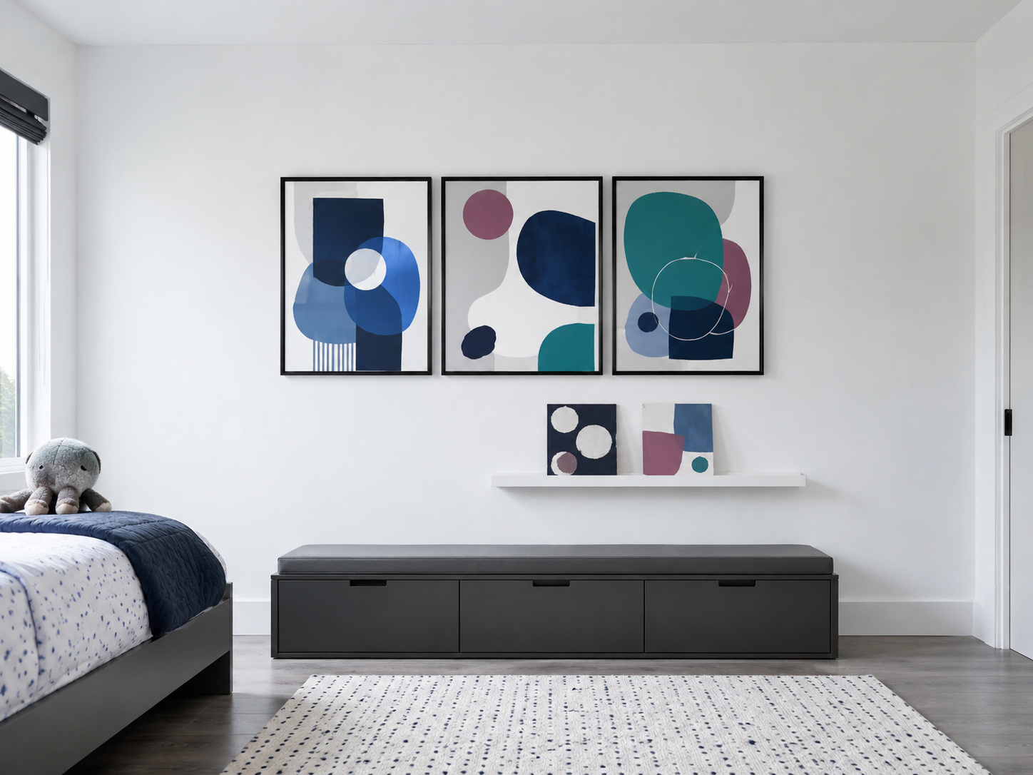 Wide kids bedroom wall balanced with framed artwork, a picture ledge and open wall space.