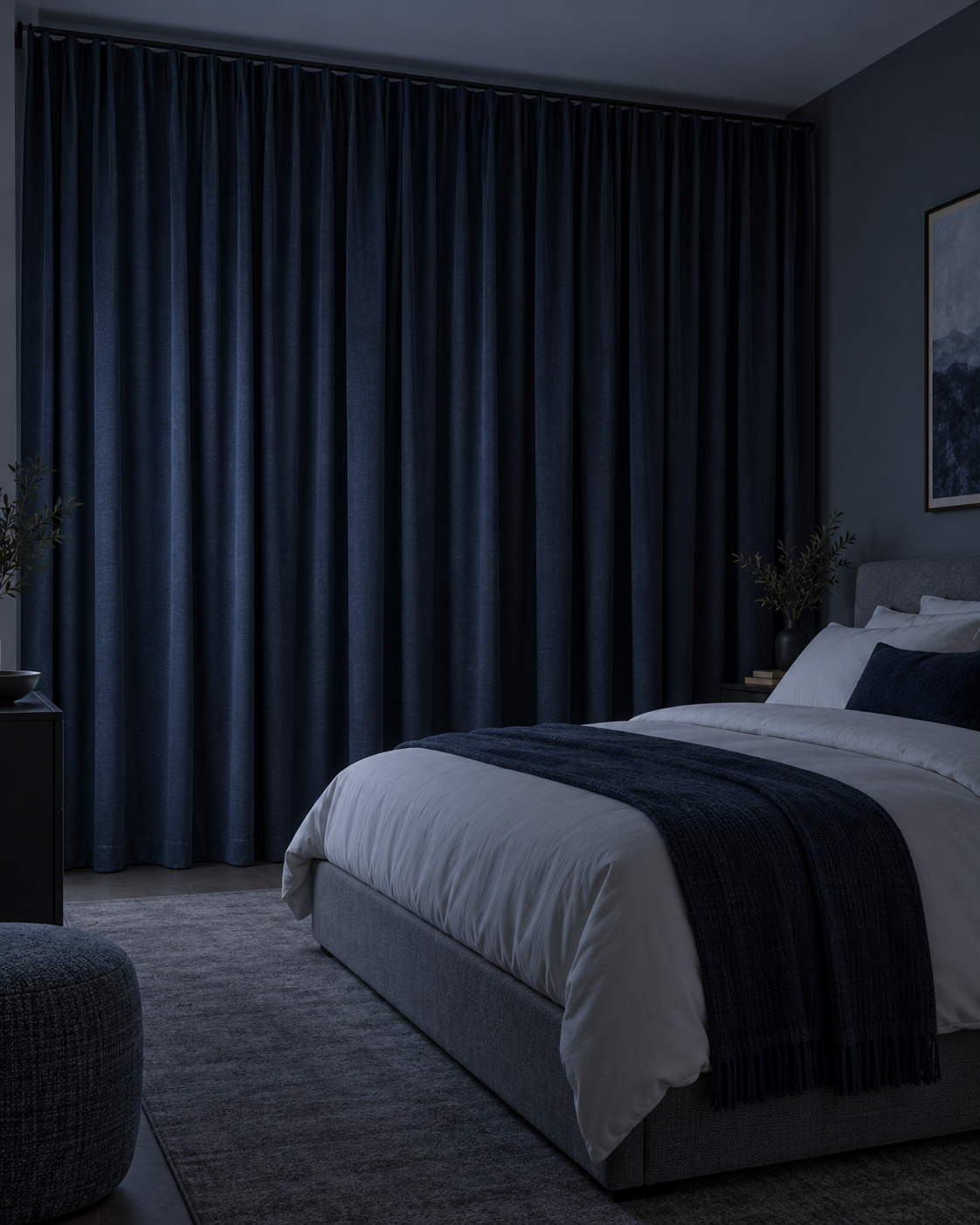 Calm cool-toned bedroom with full-length dark curtains creating a sleep-focused window treatment.