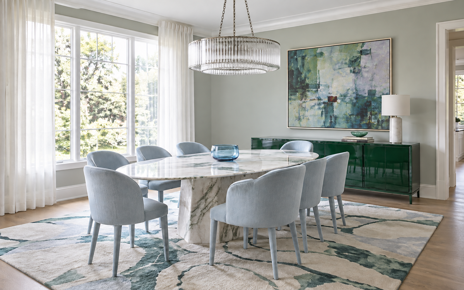 Fresh eucalyptus-green dining room with powder-blue chairs, pale stone table and correctly proportioned rug in daylight.