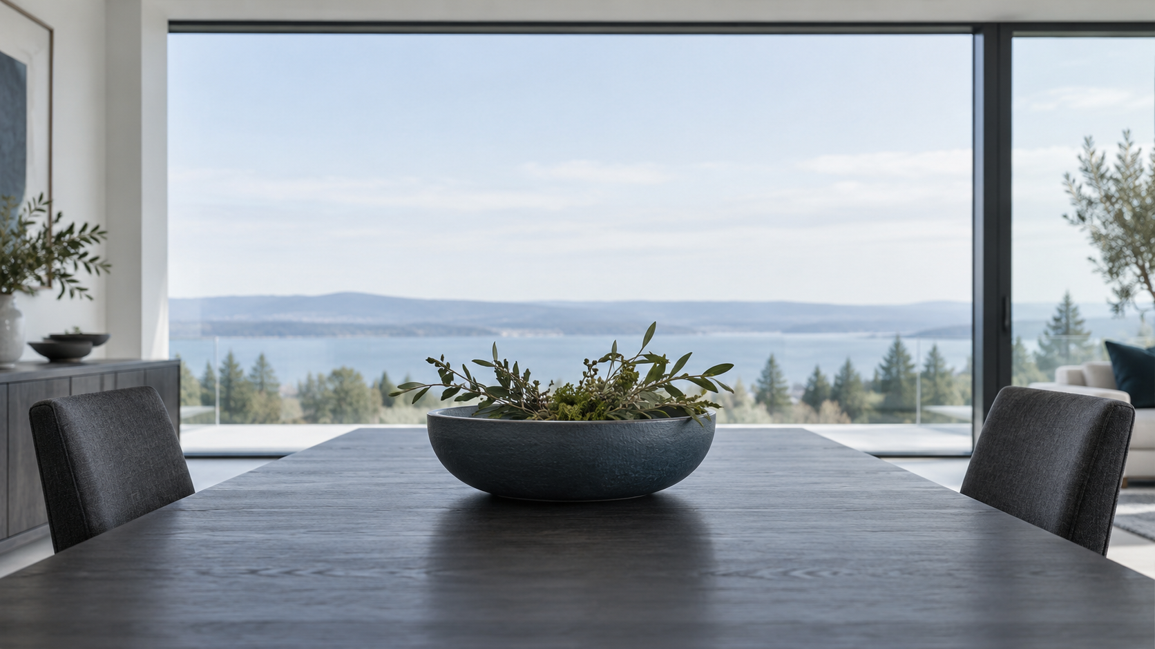 Dining Table Decor - Ravnora Decor Low dining table centerpiece seen from seated eye level with an open view across the table