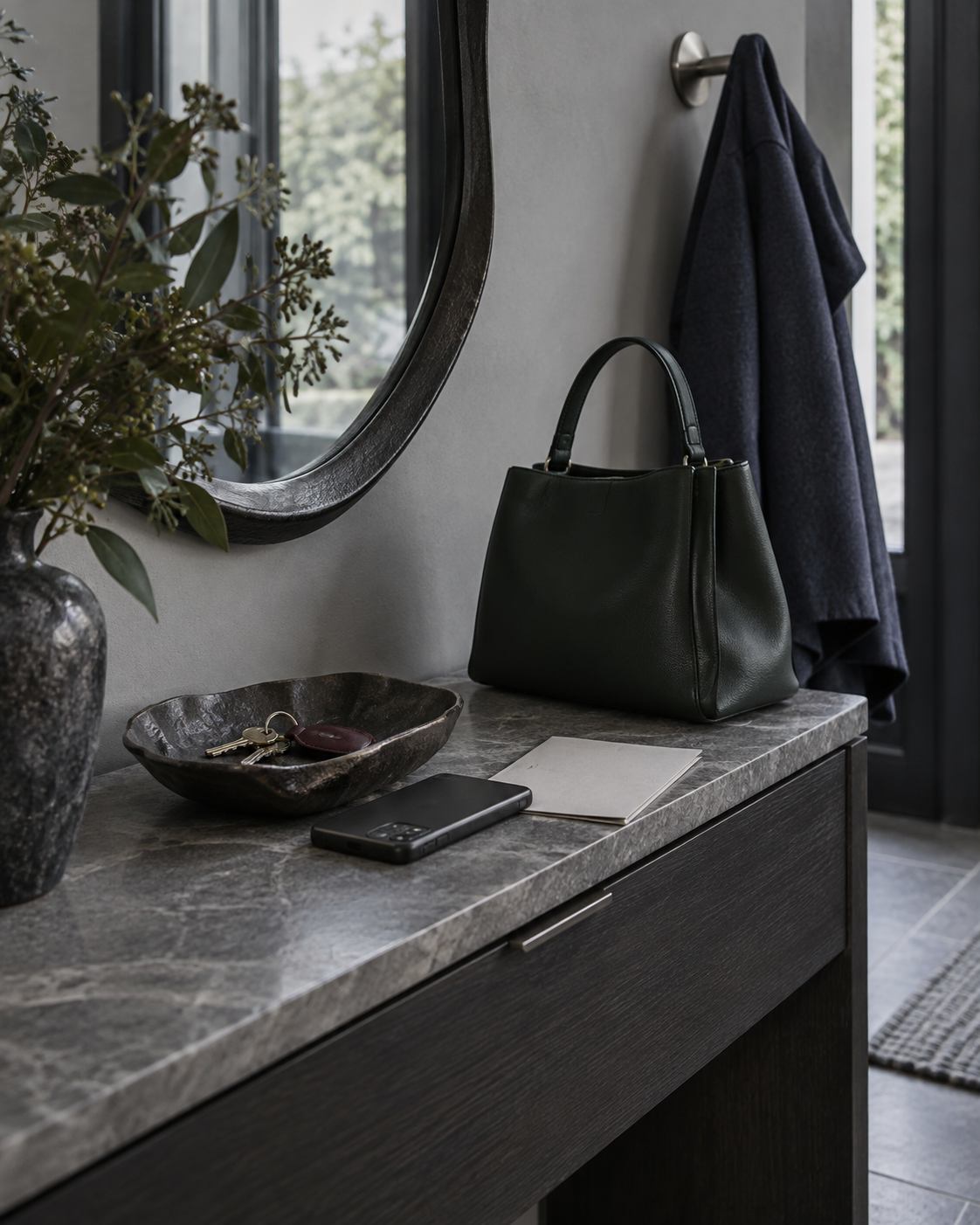 Entryway Decor Ideas - Ravnora Decor Entryway landing surface with keys, phone, handbag, mirror and coat hook