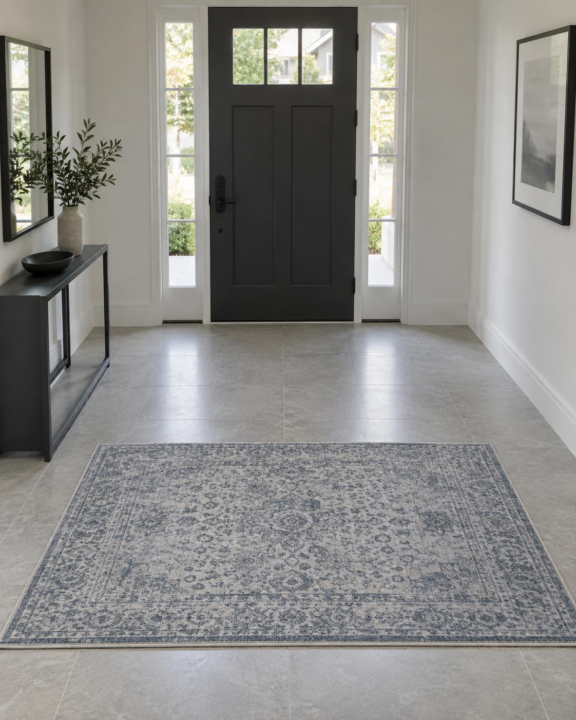 Open modern foyer with a blue-gray rectangular landing rug positioned beyond a clearly visible front-door swing zone