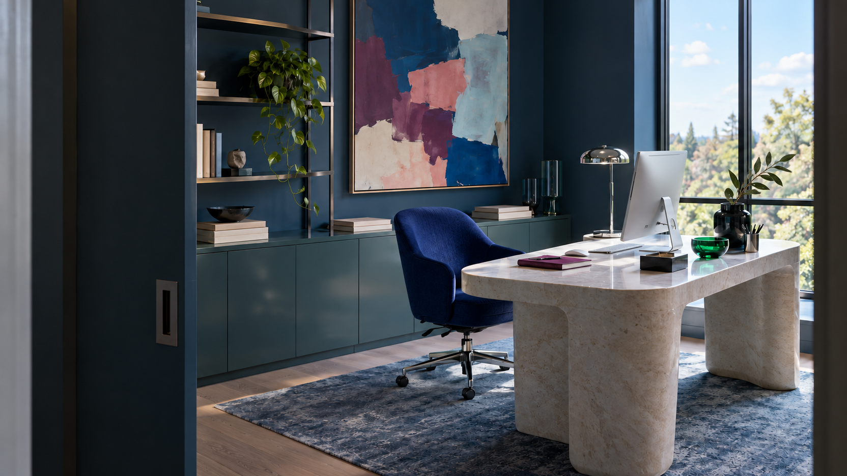 Sophisticated contemporary home office with a sculptural stone desk, cobalt chair, built-in storage, artwork and daylight.
