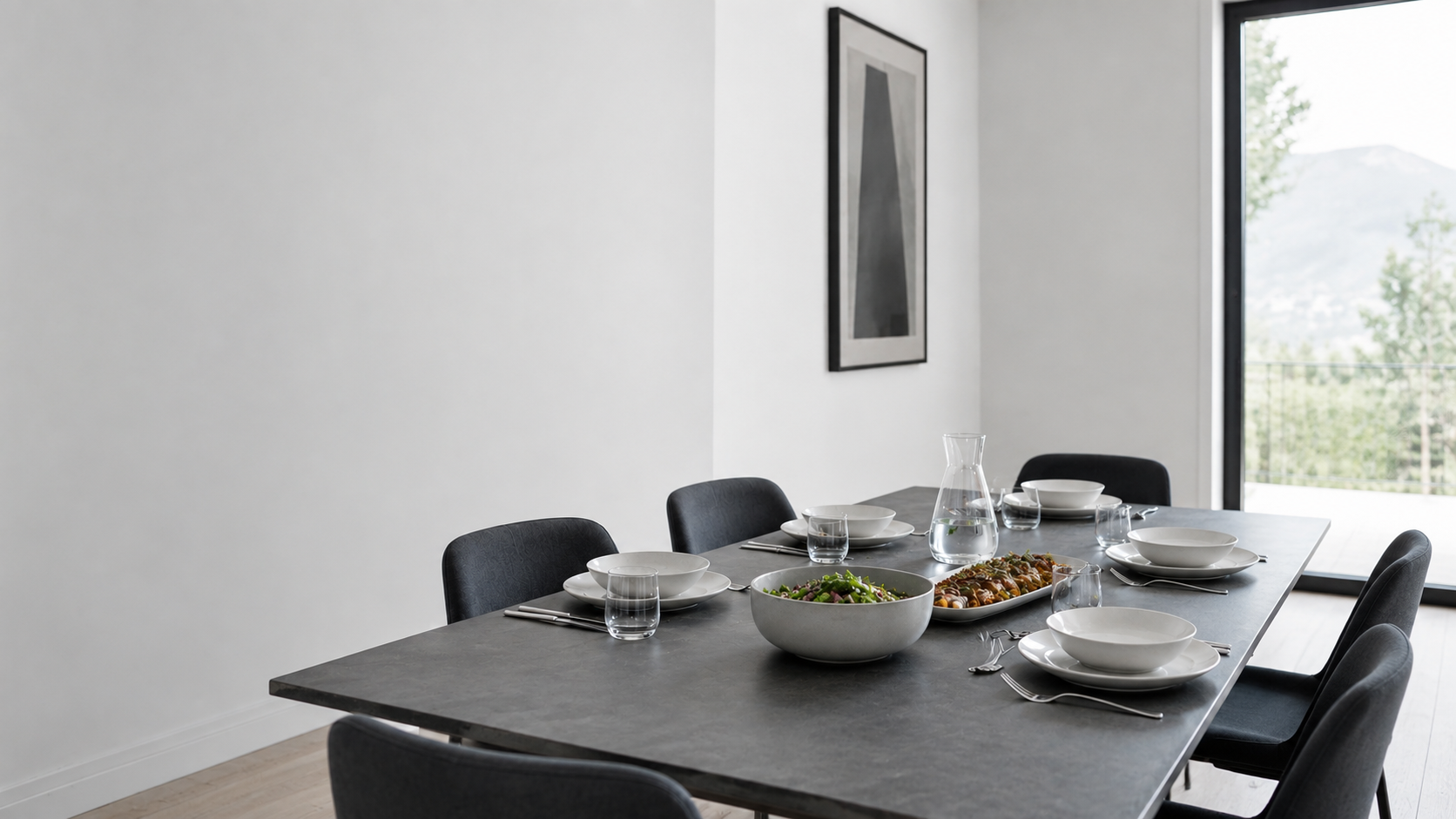 Kitchen Dinnerware & Serveware - Ravnora Decor Contemporary dining table with coordinated place settings and a deliberately clear centerline for shared serving pieces.