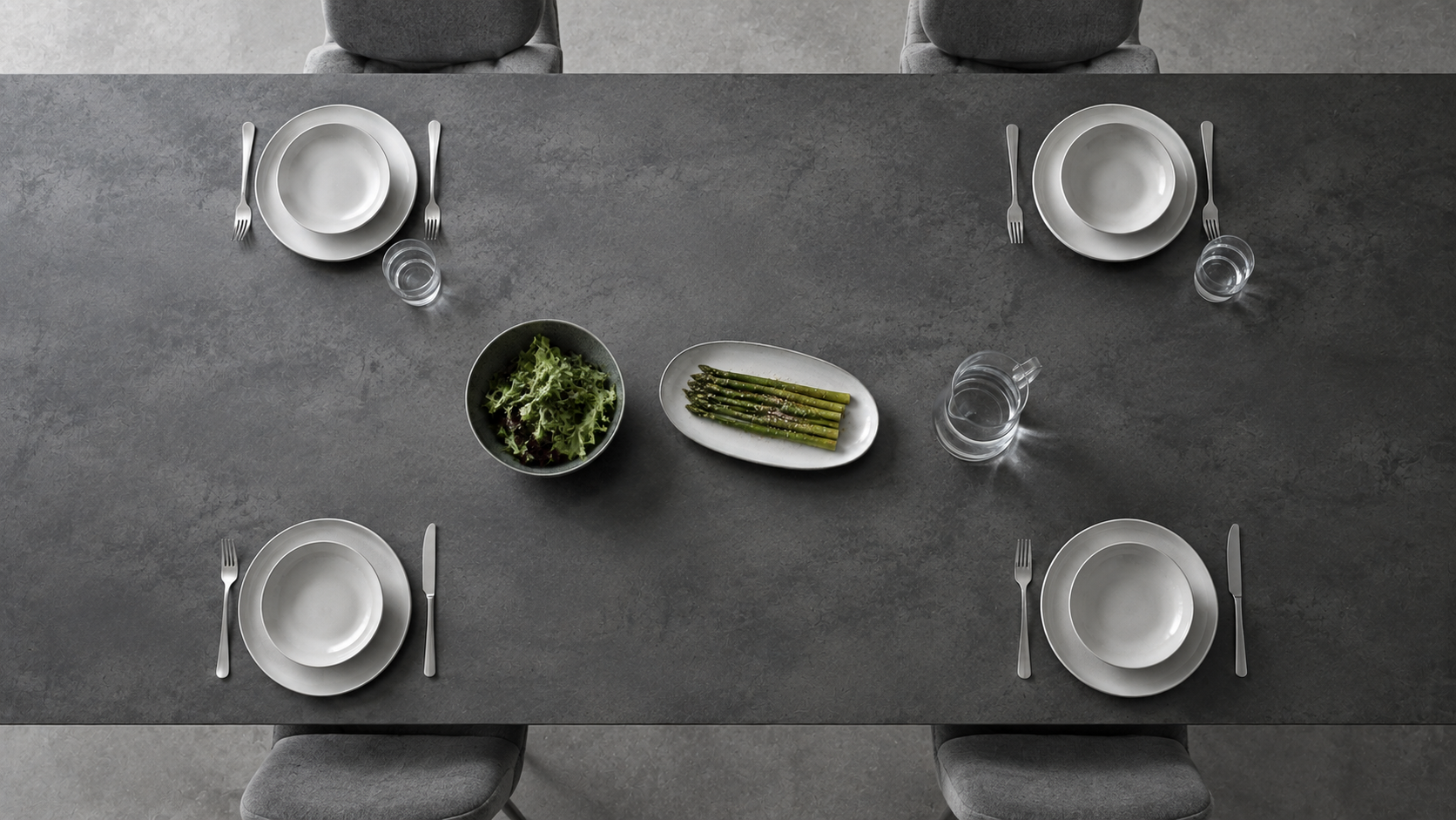 Top-down four-person table showing shared serving bowls and platters spaced along a clear central pass line.