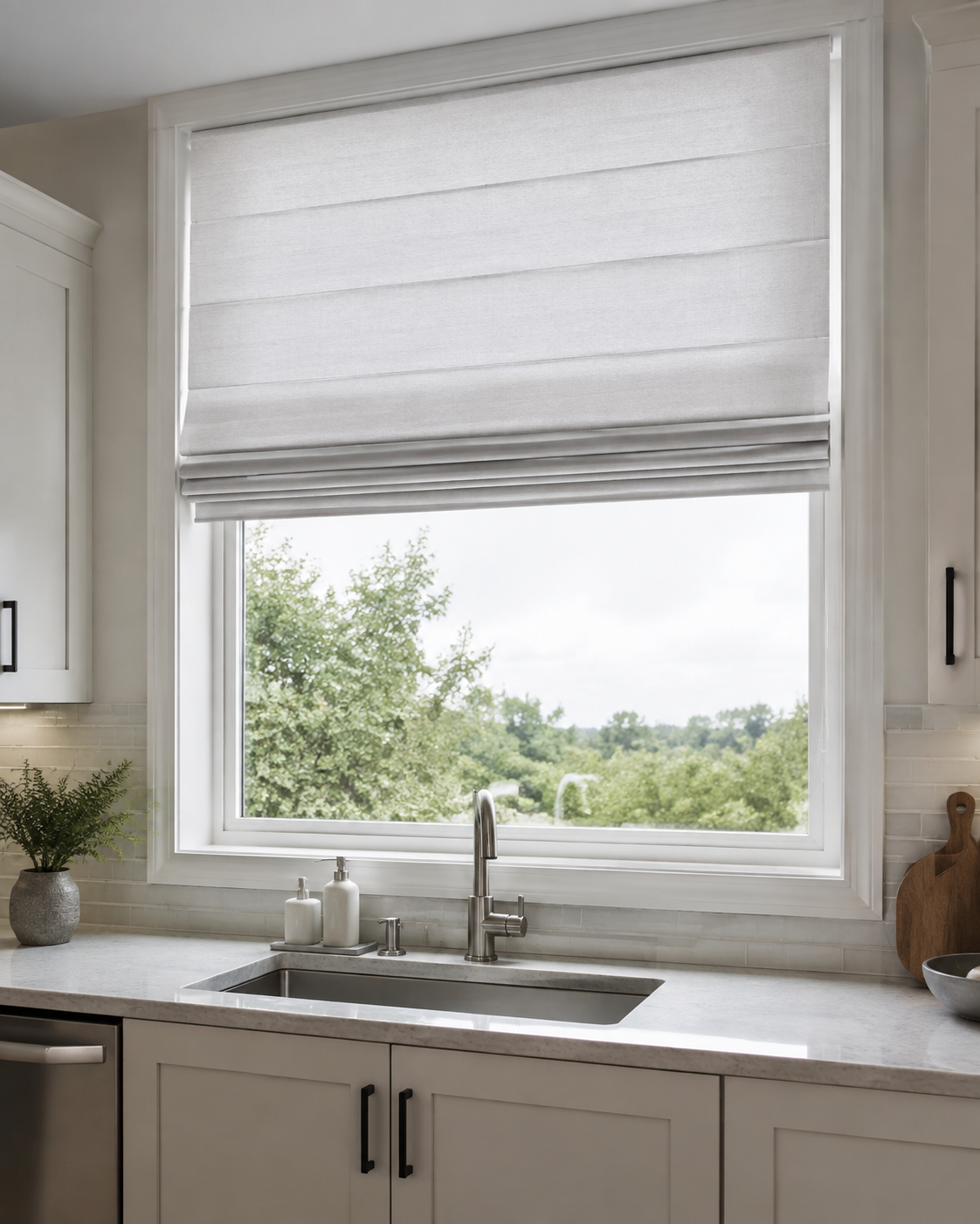 Kitchen Curtains & Window Styling - Ravnora Decor Pale fabric Roman shade partially lowered over a contemporary kitchen window for adjustable coverage.