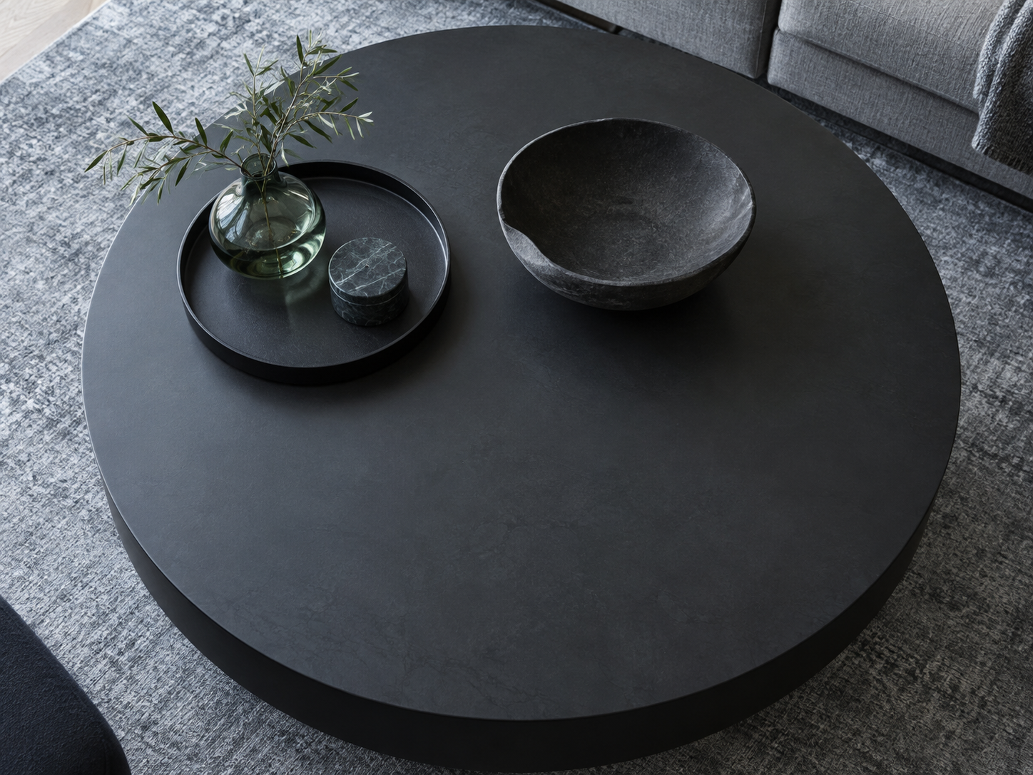 Living Room Decorative Accessories - Ravnora Decor Dark coffee table using one tray and one bowl while leaving substantial usable surface clear.
