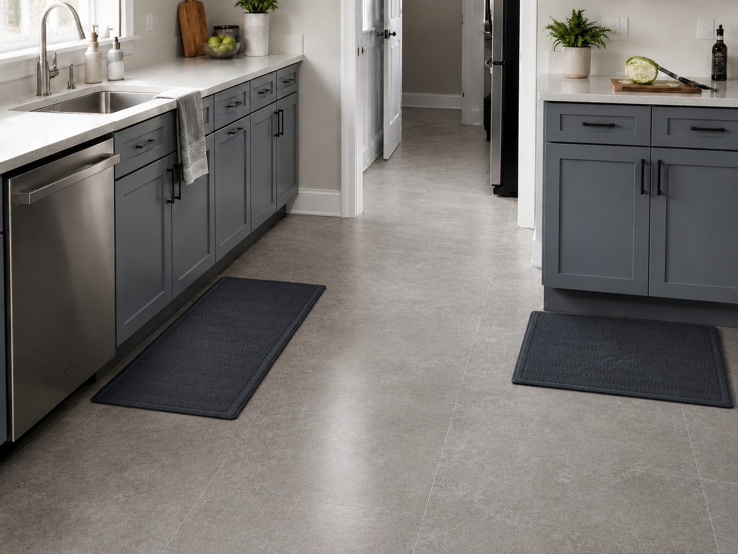Contemporary kitchen with exactly two separate standing mats at the sink and prep work zones, leaving the circulation floor clear.