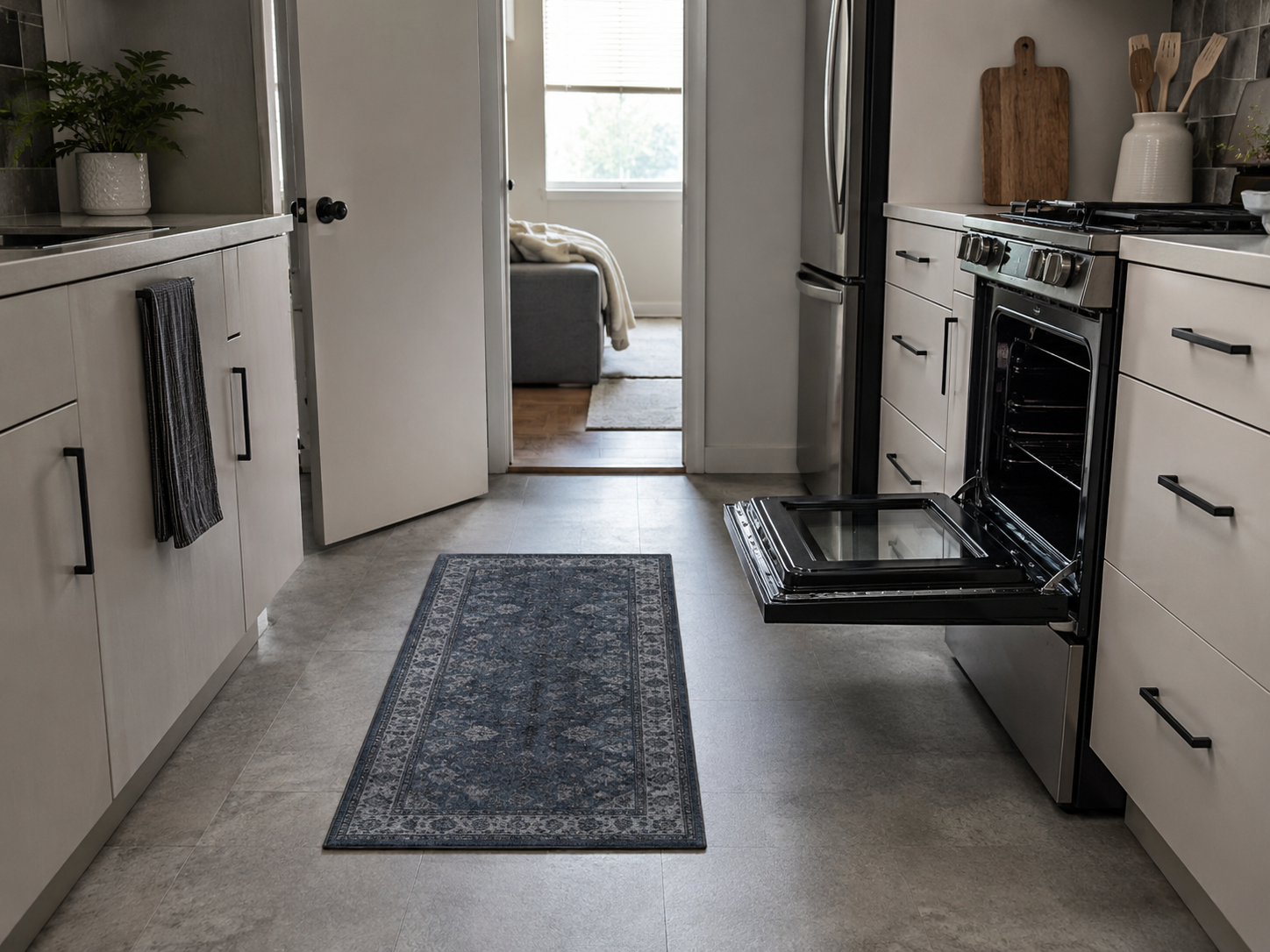 Small apartment kitchen using a compact low-profile rug that stays clear of nearby doors and appliances.