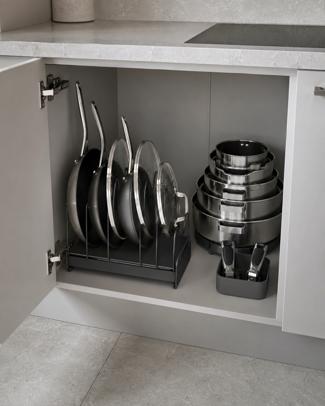 Kitchen Cookware & Bakeware Essentials - Ravnora Decor Open cookware cabinet with pans and lids organized vertically beside a compact nested cookware system.
