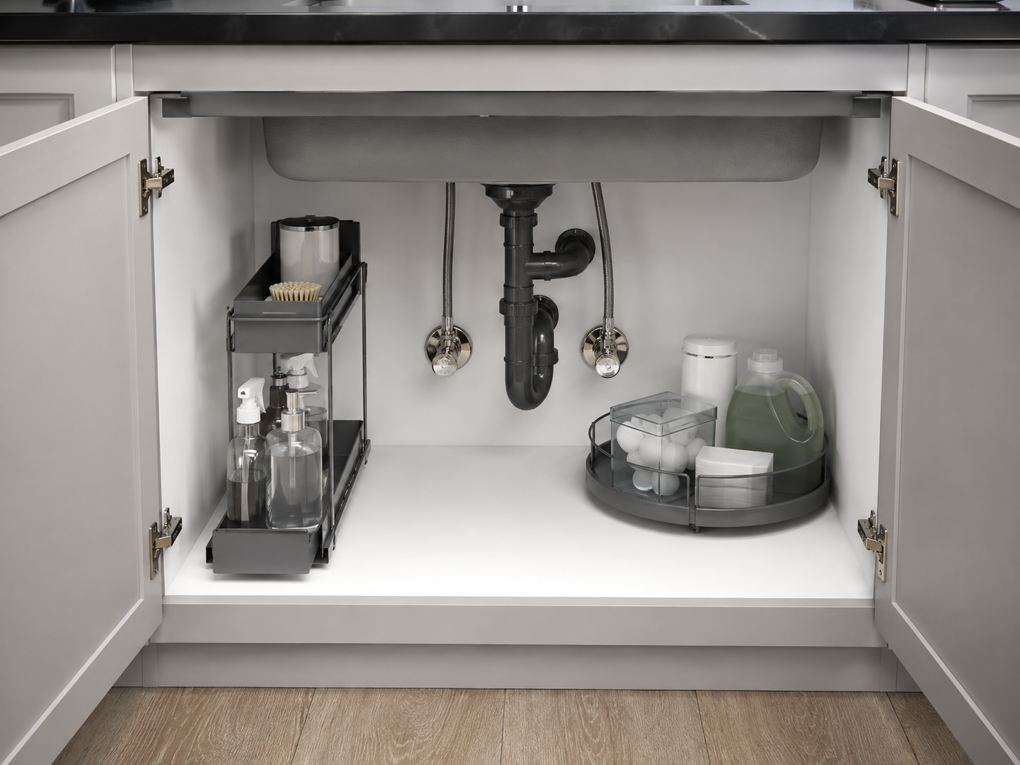 Kitchen Cleaning & Trash Solutions - Ravnora Decor Open under-sink cabinet with front-access cleaning storage, rear reserve organization and visible unobstructed plumbing.