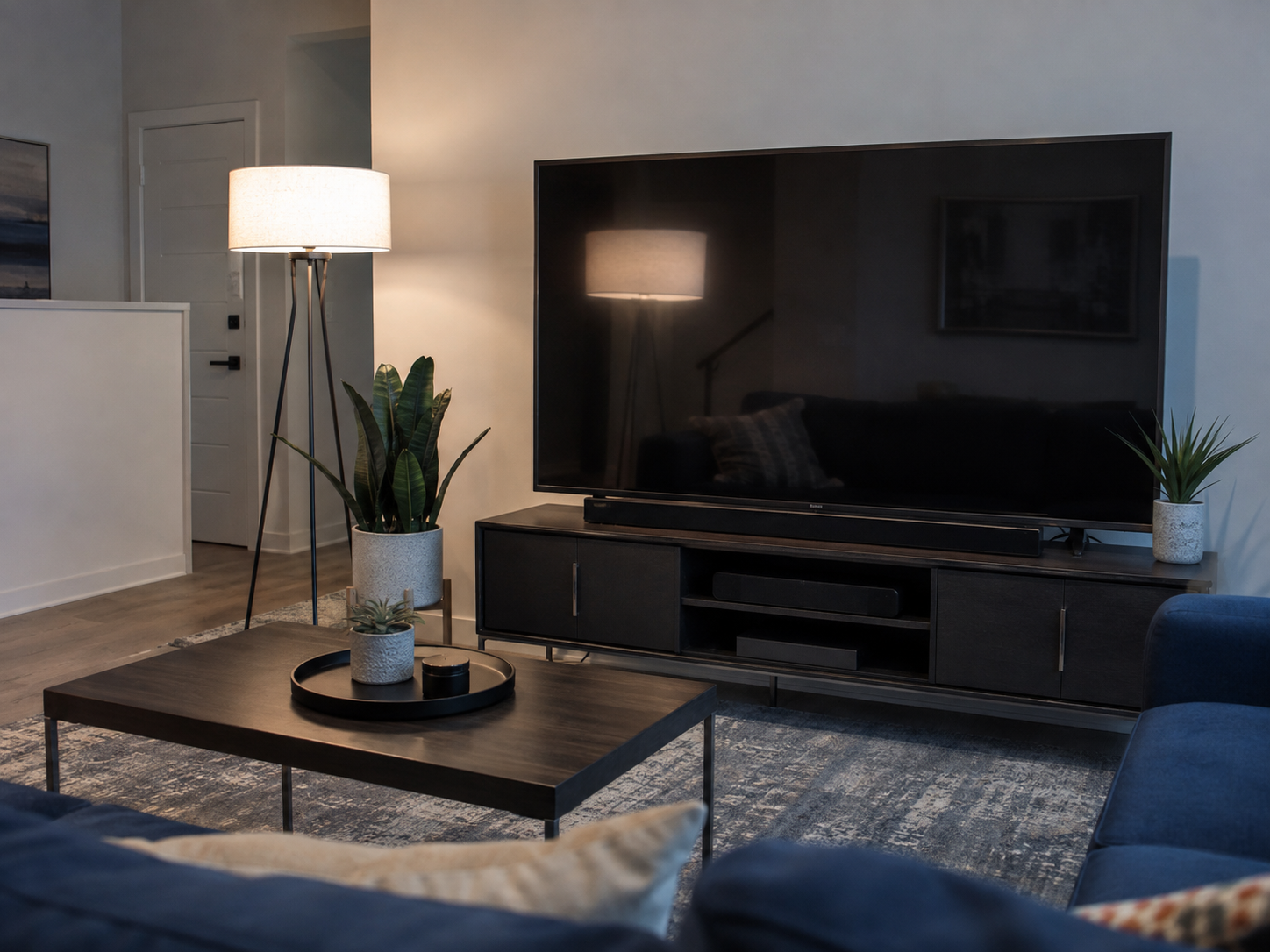 Living-room TV with a bright lamp reflection demonstrating glare from poor light placement.